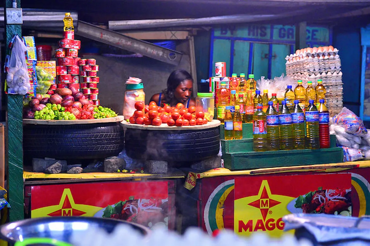 A market stall in Accra, Ghana with tomatoes, oil and peppers.