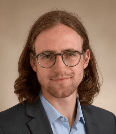 A professional headshot of Dorian Barker, the SaaS copywriter