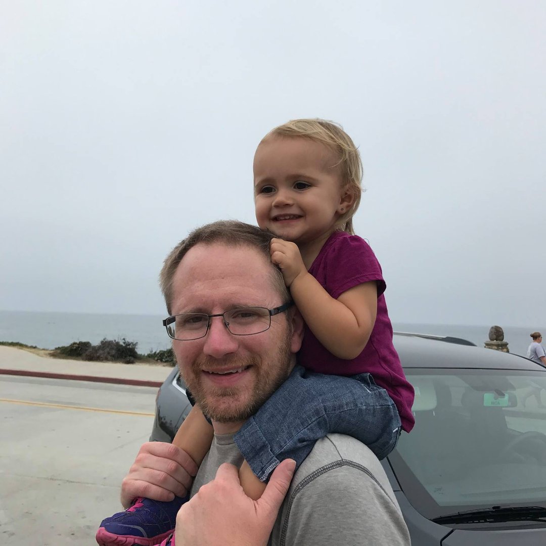 man in gray suit jacket wearing black framed eyeglasses
