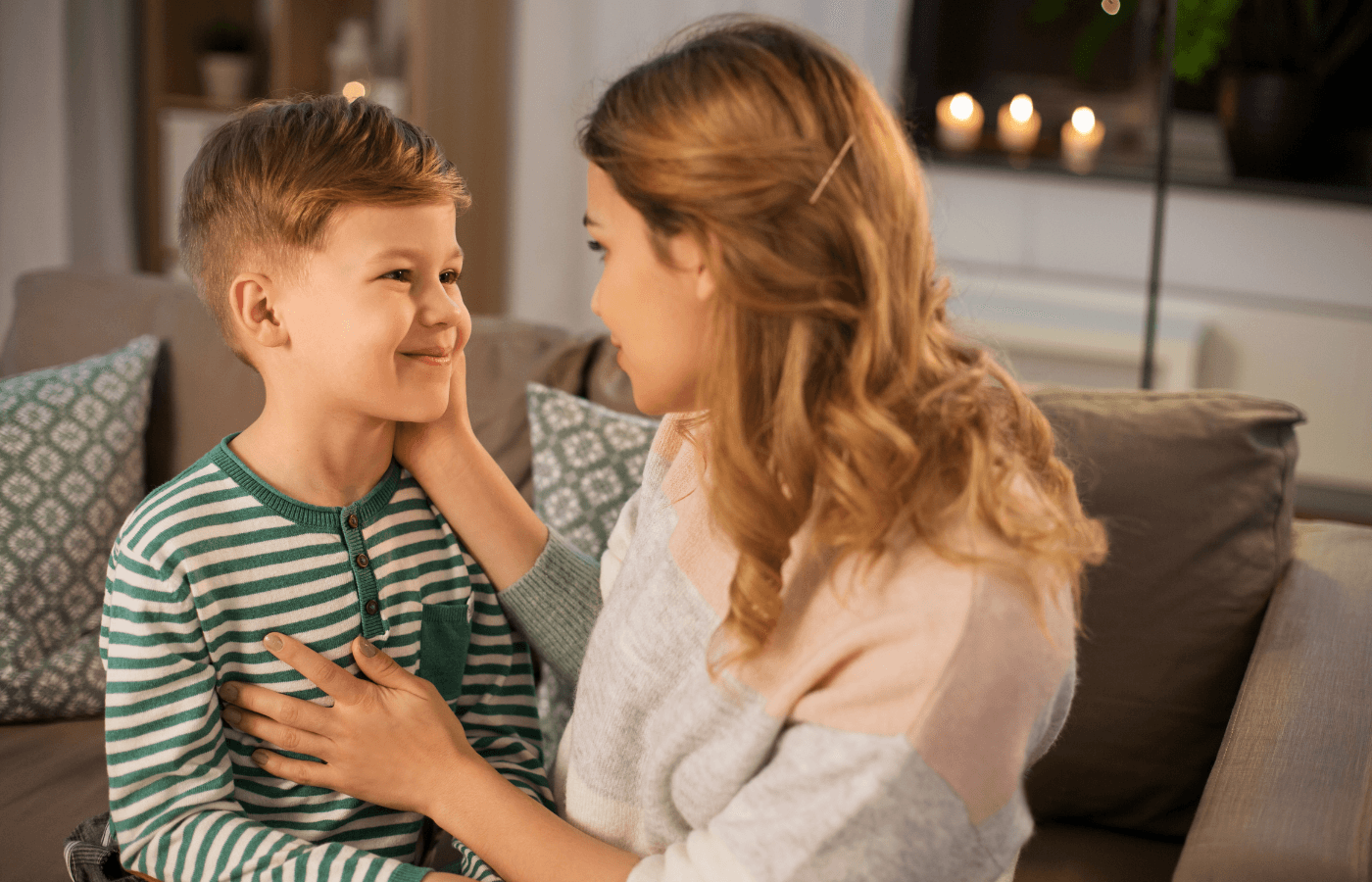 smiling mother talking to her son at home