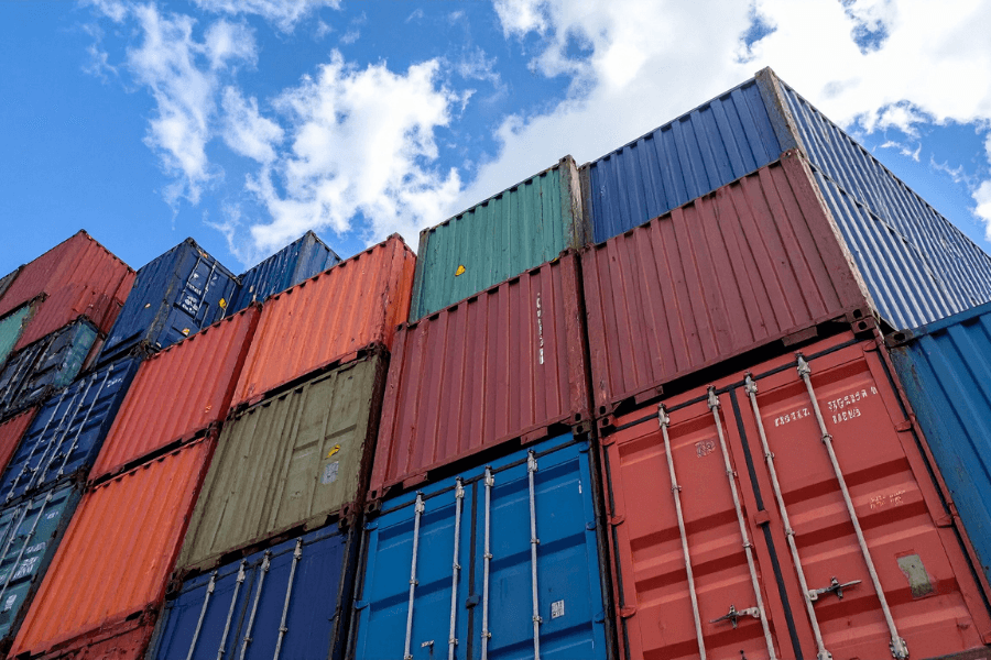 Stacked shipping containers at a depot ready for VGM verification.