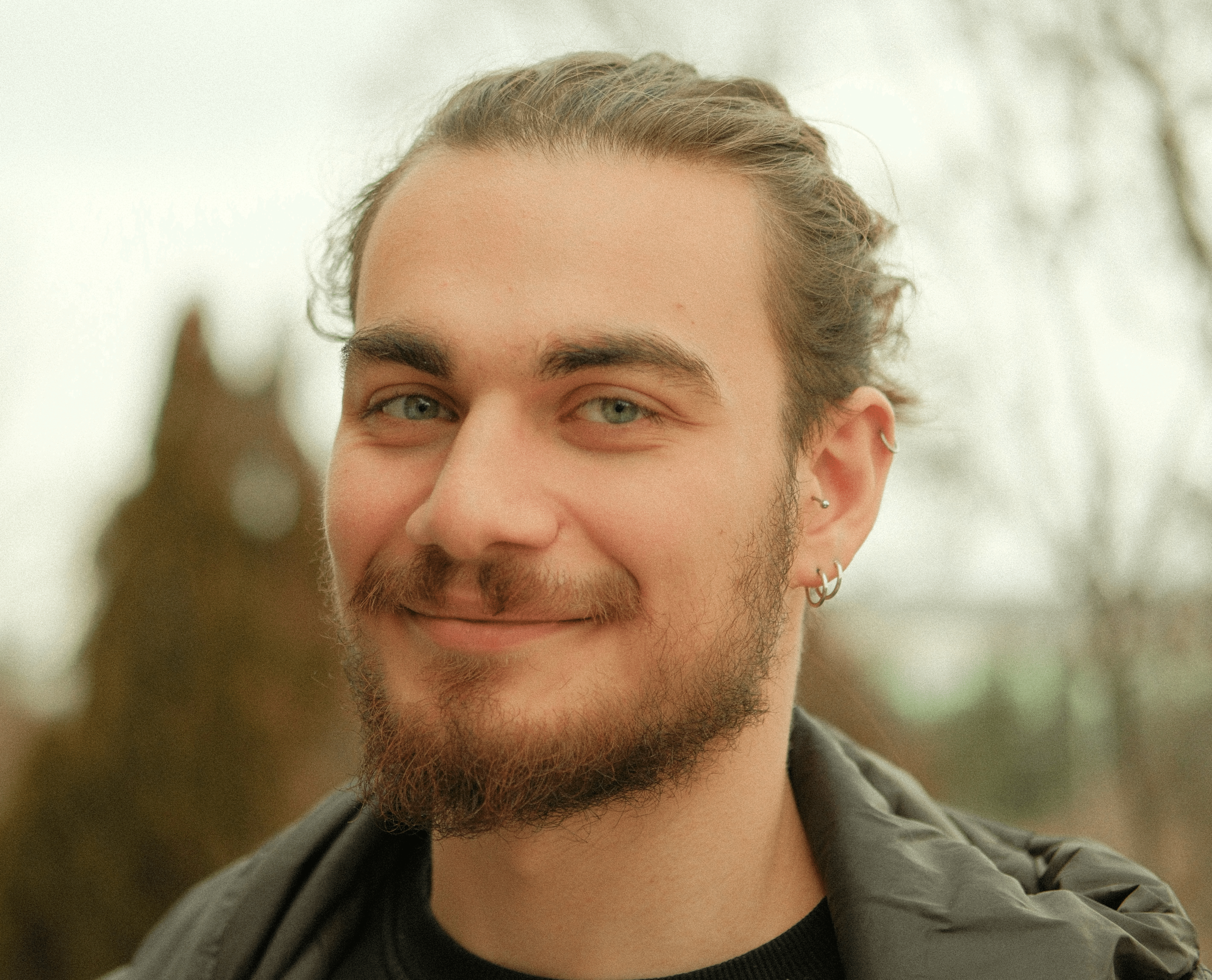 A man with a beard and a black shirt