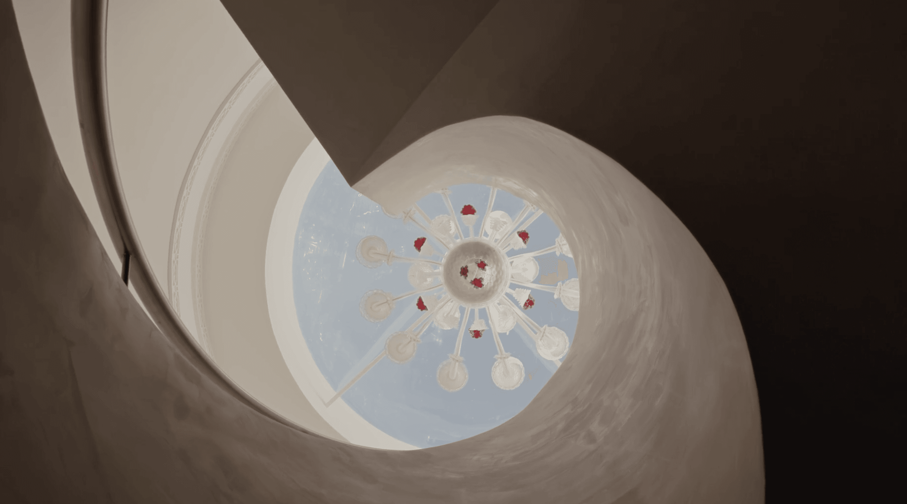 a large building with a red and white tower