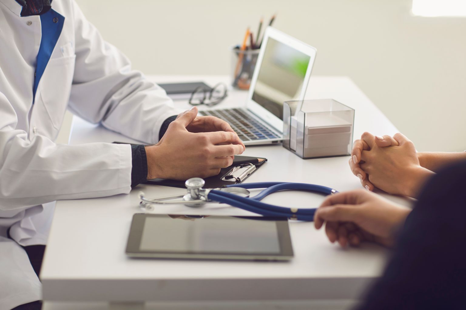 Doctor discussing care with a patient during a medical consultation.