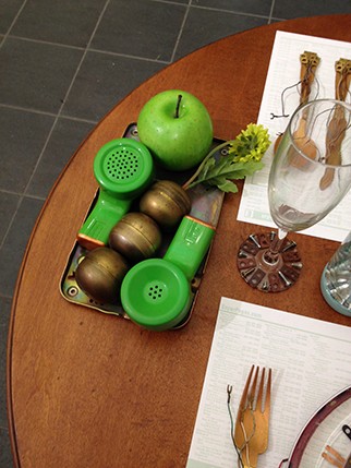 green apple with silverwares and wine cups