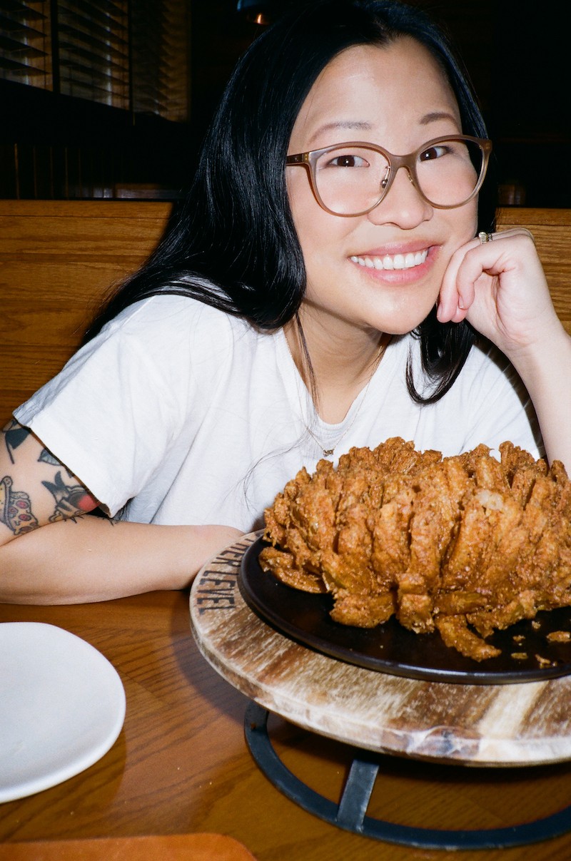 Asian woman with a fried onion