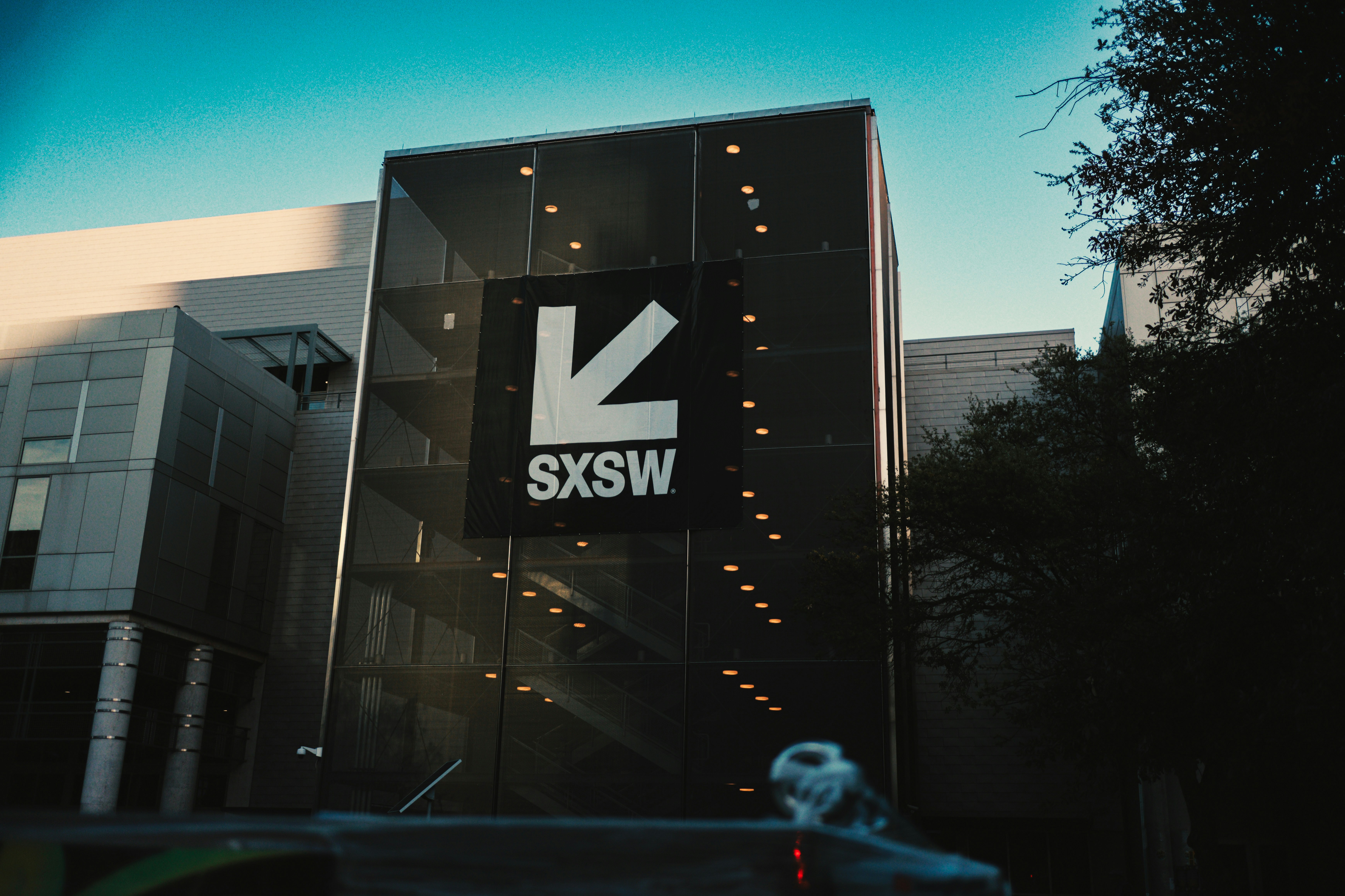 Sxsw building with large logo under blue sky