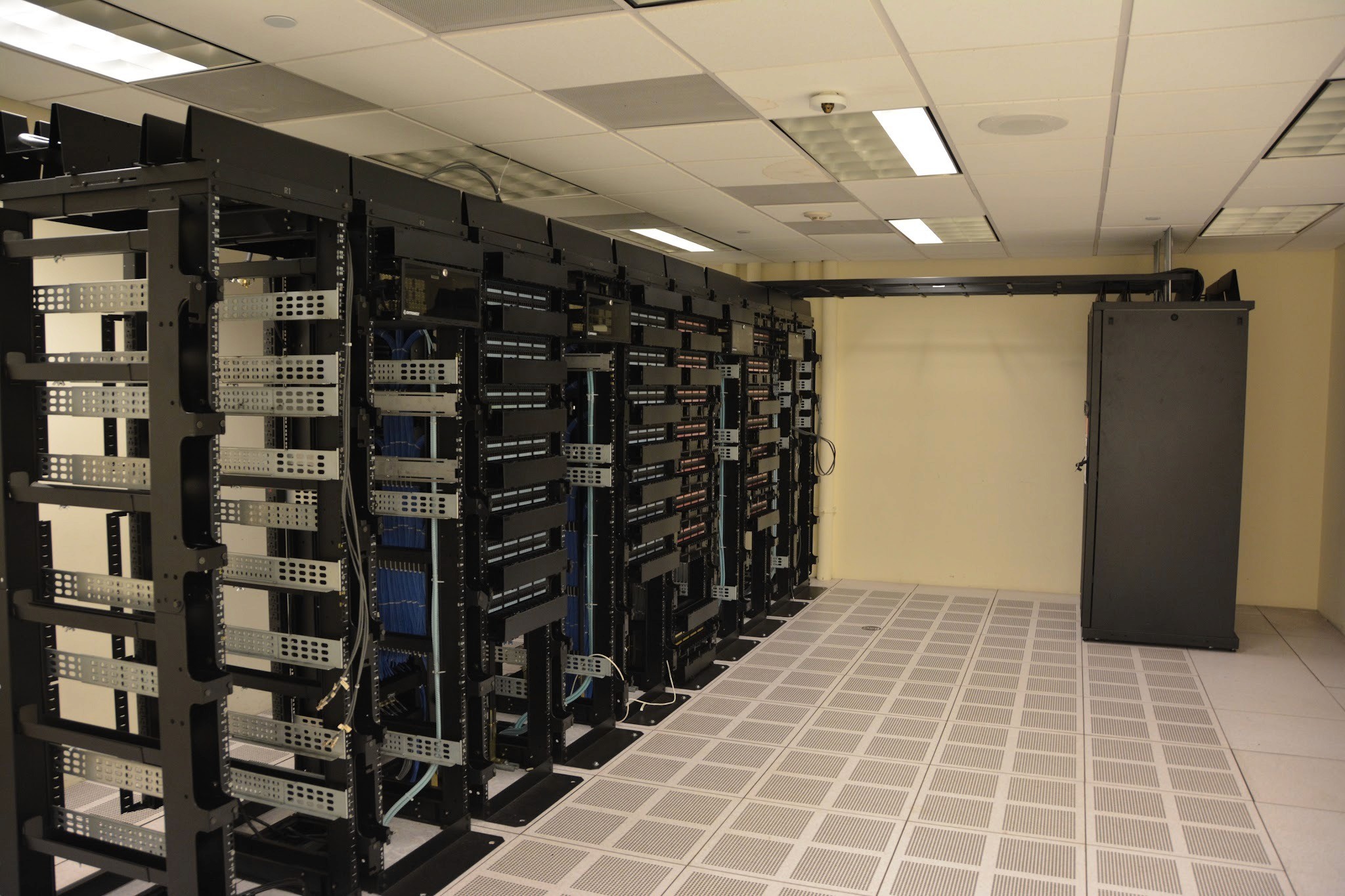 Rows of GPU server racks in a large data center, illustrating the centralized compute behind OpenAI's GPT-6 Astra
