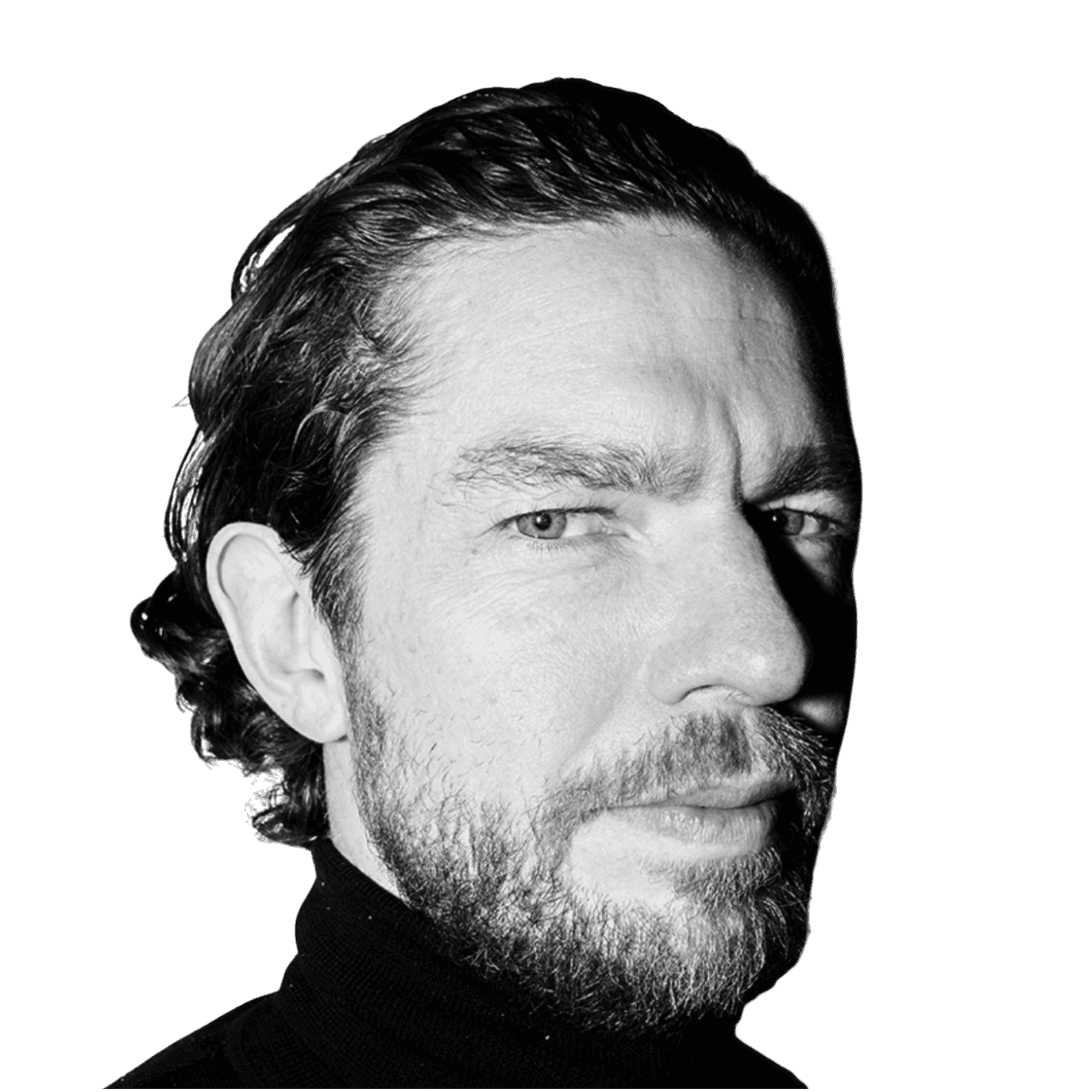 A young person with curly hair smiles at the camera while sitting in front of a laptop against a dark background. (Background Removed)