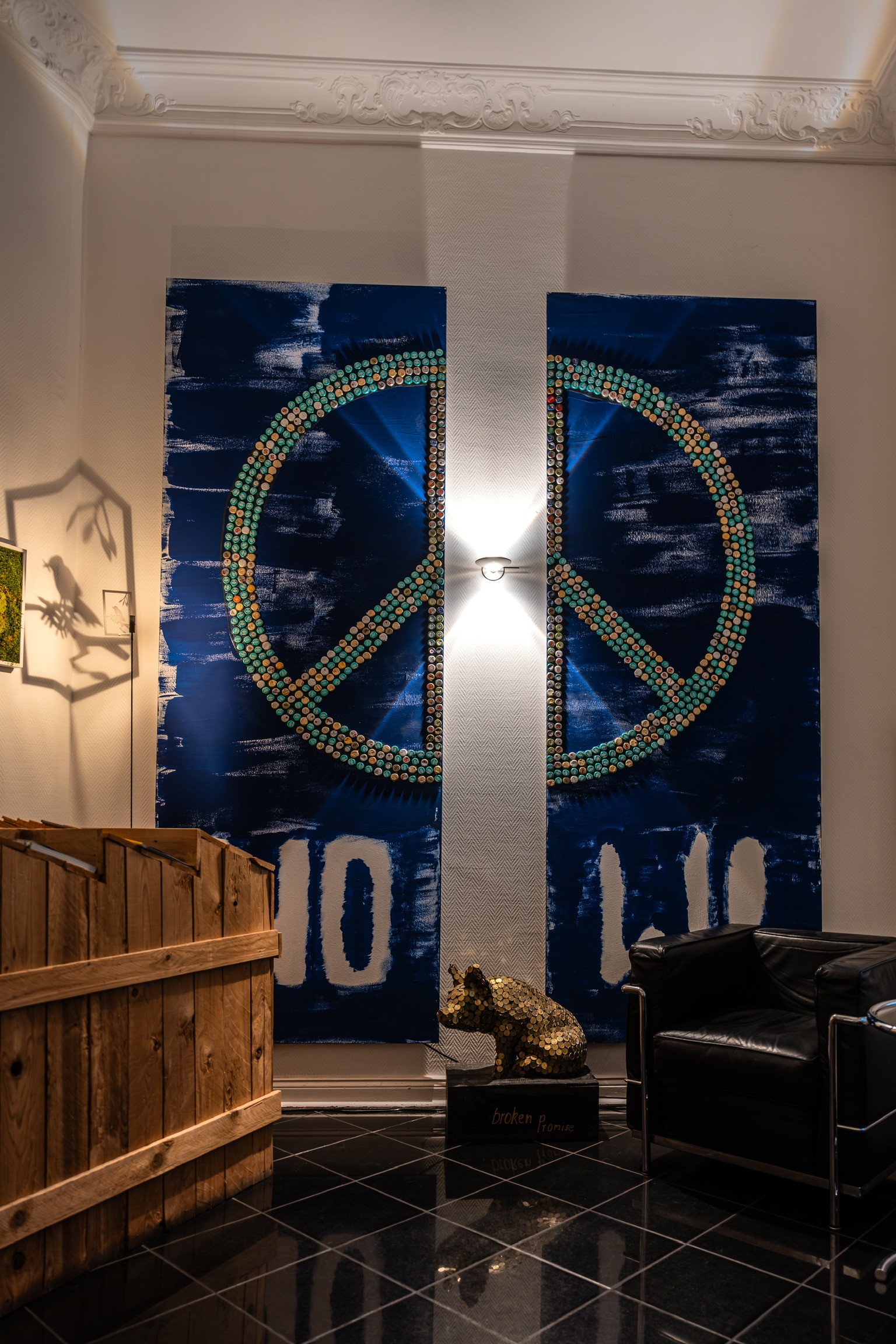 Close-up of a dark green leaf showing its textured surface and central vein against a muted background.
