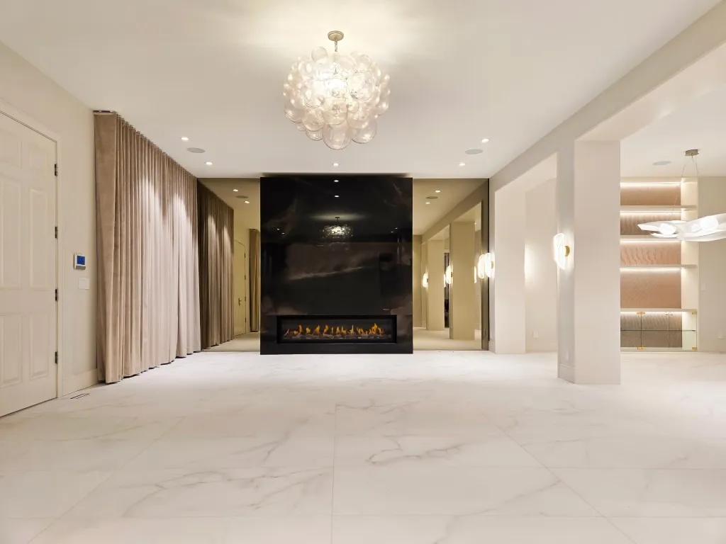 Image of KHD Homes design-build interior with luxury fireplace, marble floors, and elegant lighting fixtures layout design.