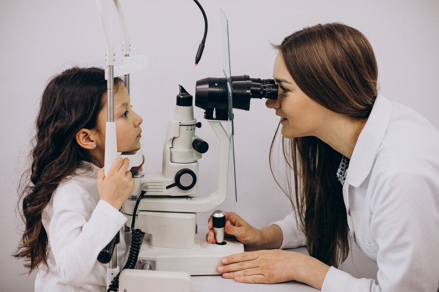 A little girl getting her eyesight checked by her doctor.