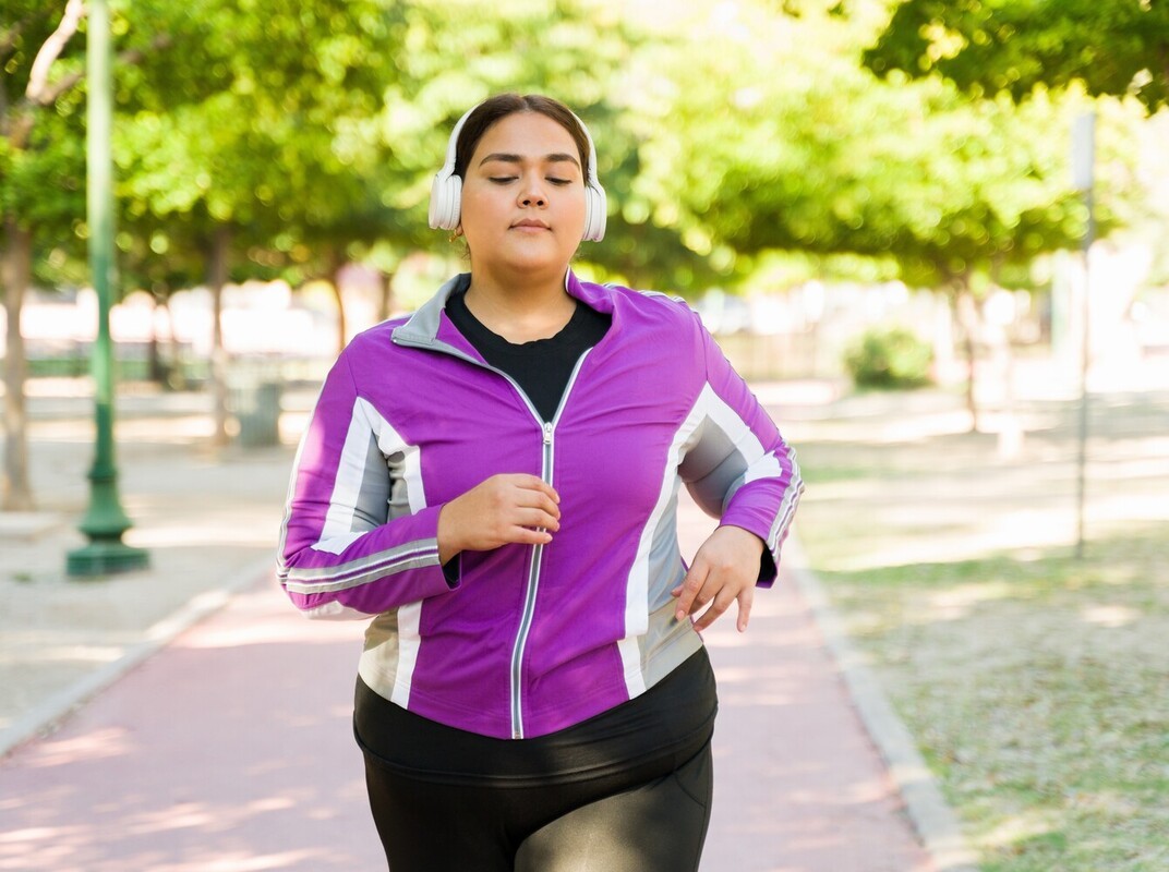 overweight woman going on a run to complement her chair workouts for weight loss
