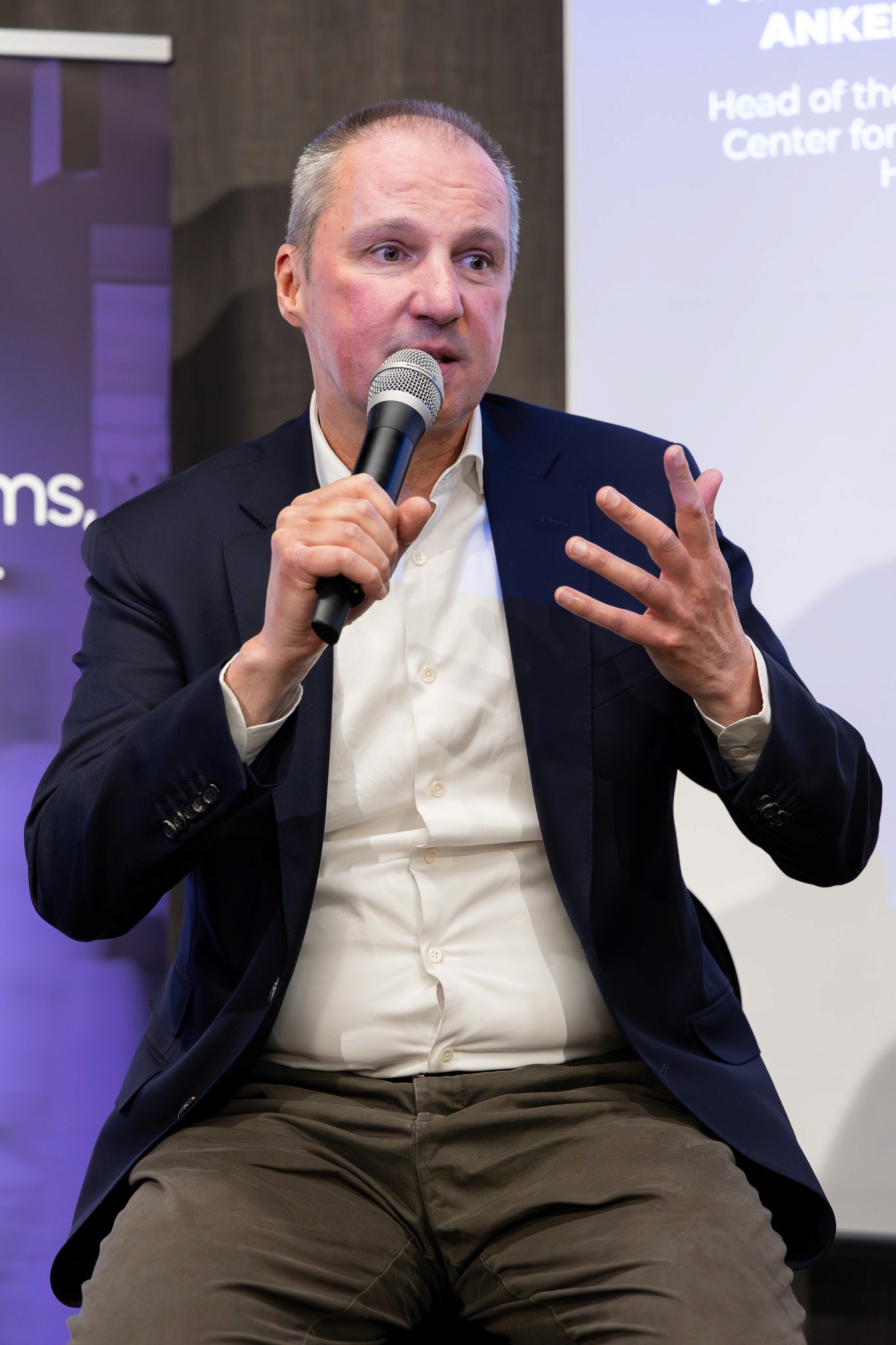 Speaker sharing insights during a live blockchain panel.