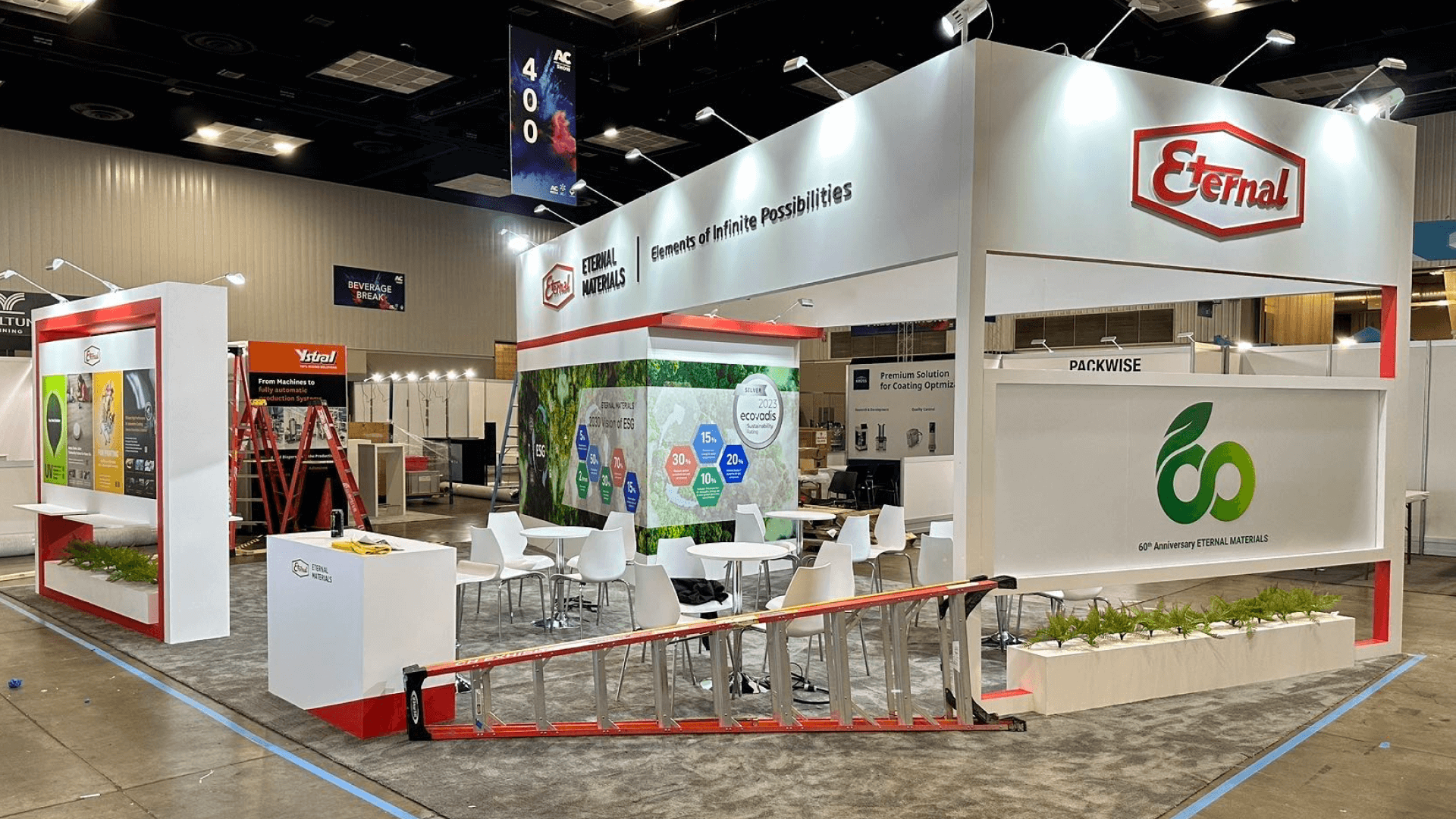 Portable trade show booth with coordinated graphics, screen, counter, and product presentation arranged as one visual composition.