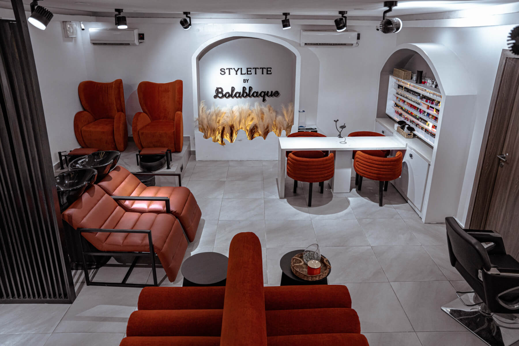 A living room with a couch, two chairs, a coffee table, and a fireplace.