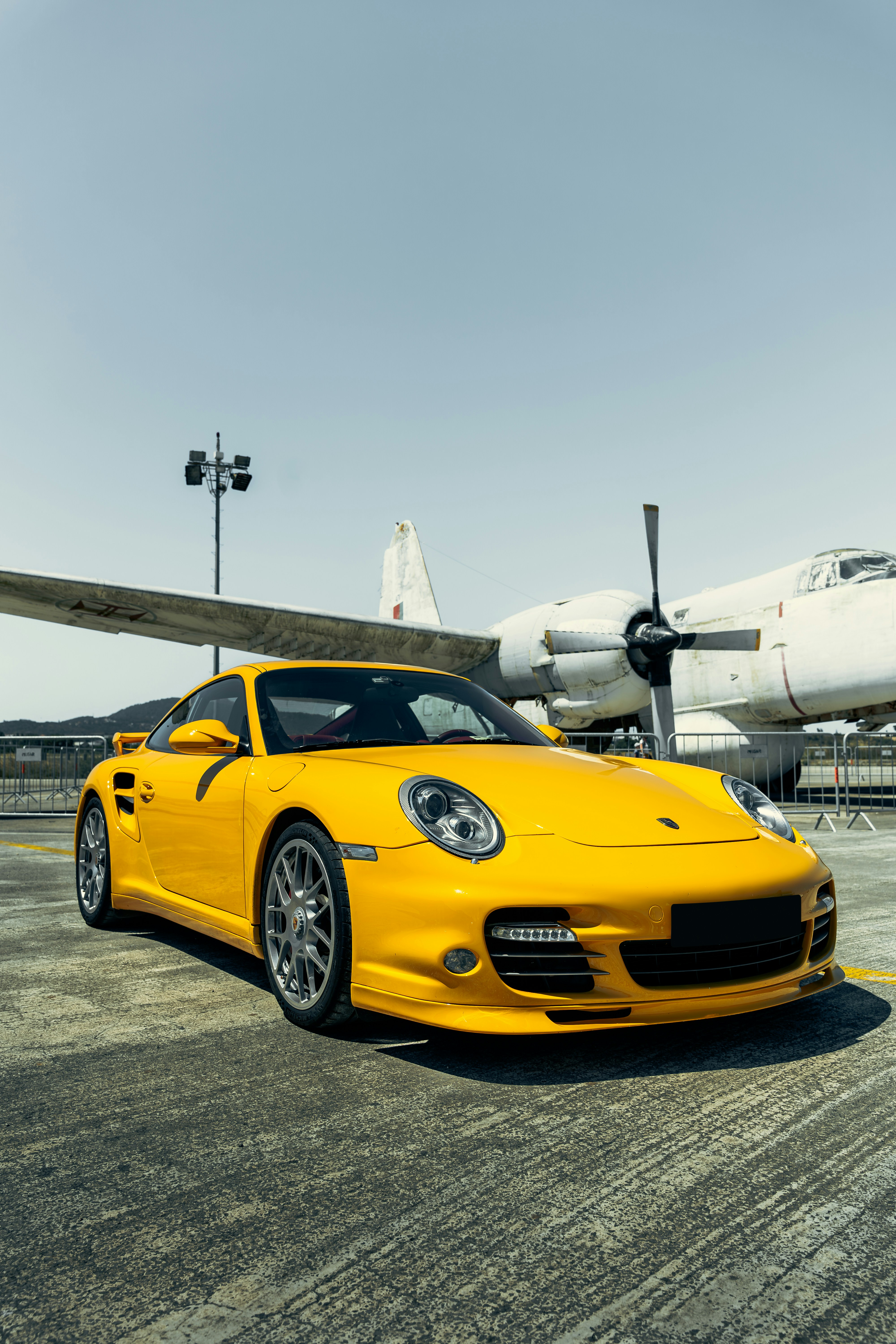 a yellow car parked in a showroom