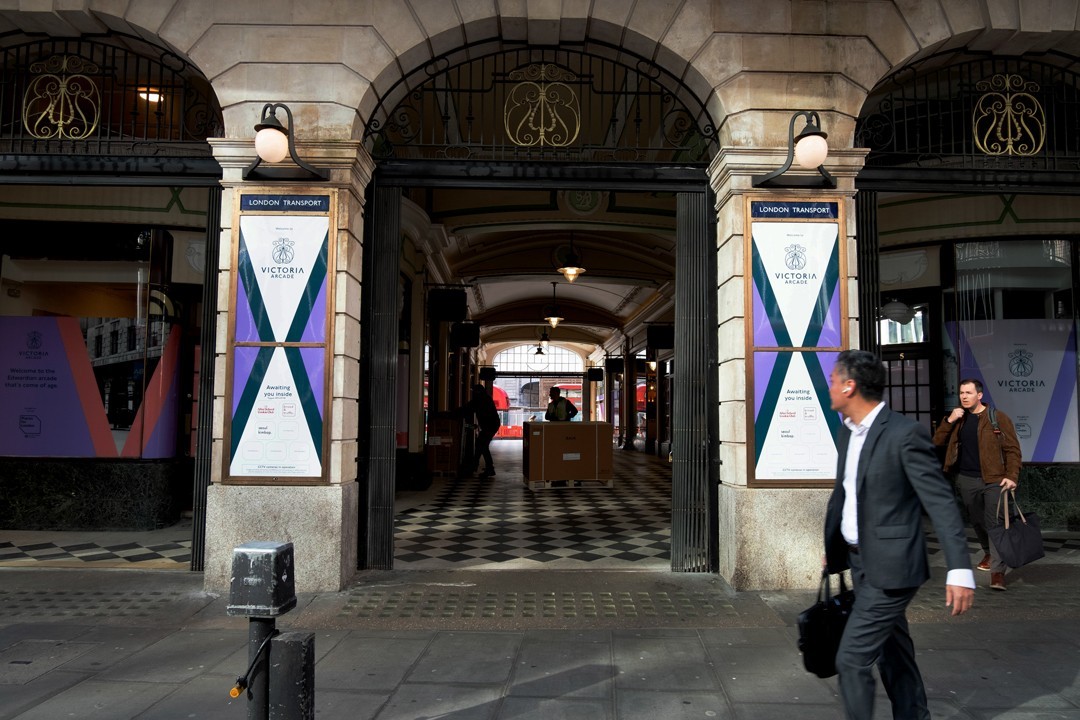 White branded cap with turquoise logo placed on fresh lemons in a red bowl