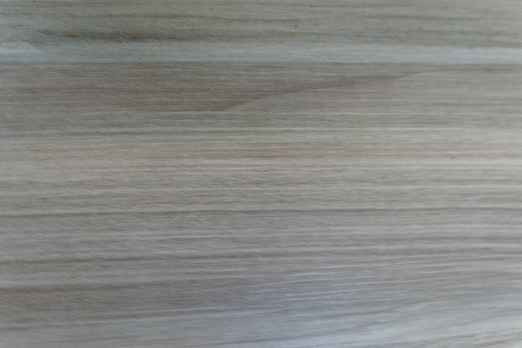 A close-up of a light brown wood grain texture.