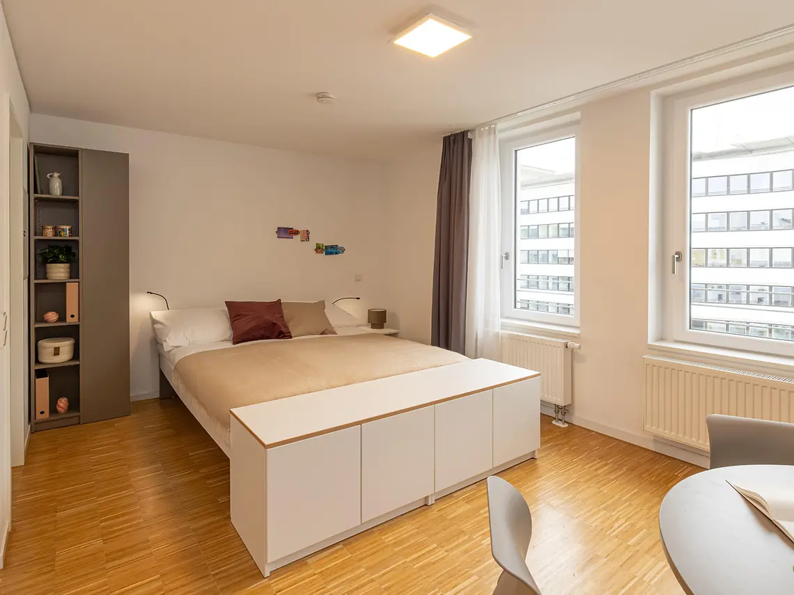 Bright student studio bedroom in Frankfurt with double bed and natural light