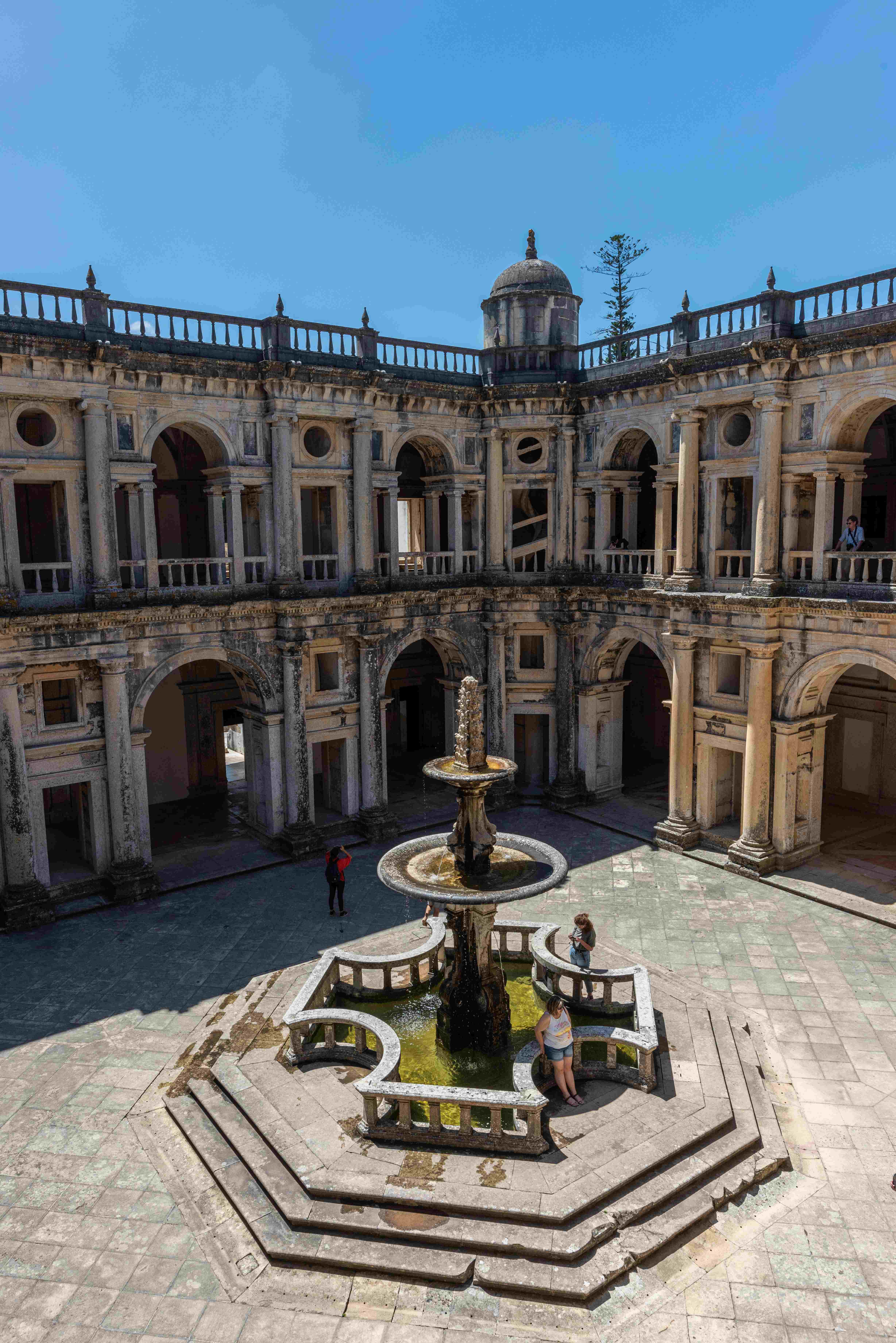 Patio interior en Querétaro con una fuente central, rodeada de arcos históricos y arquitectura colonial.