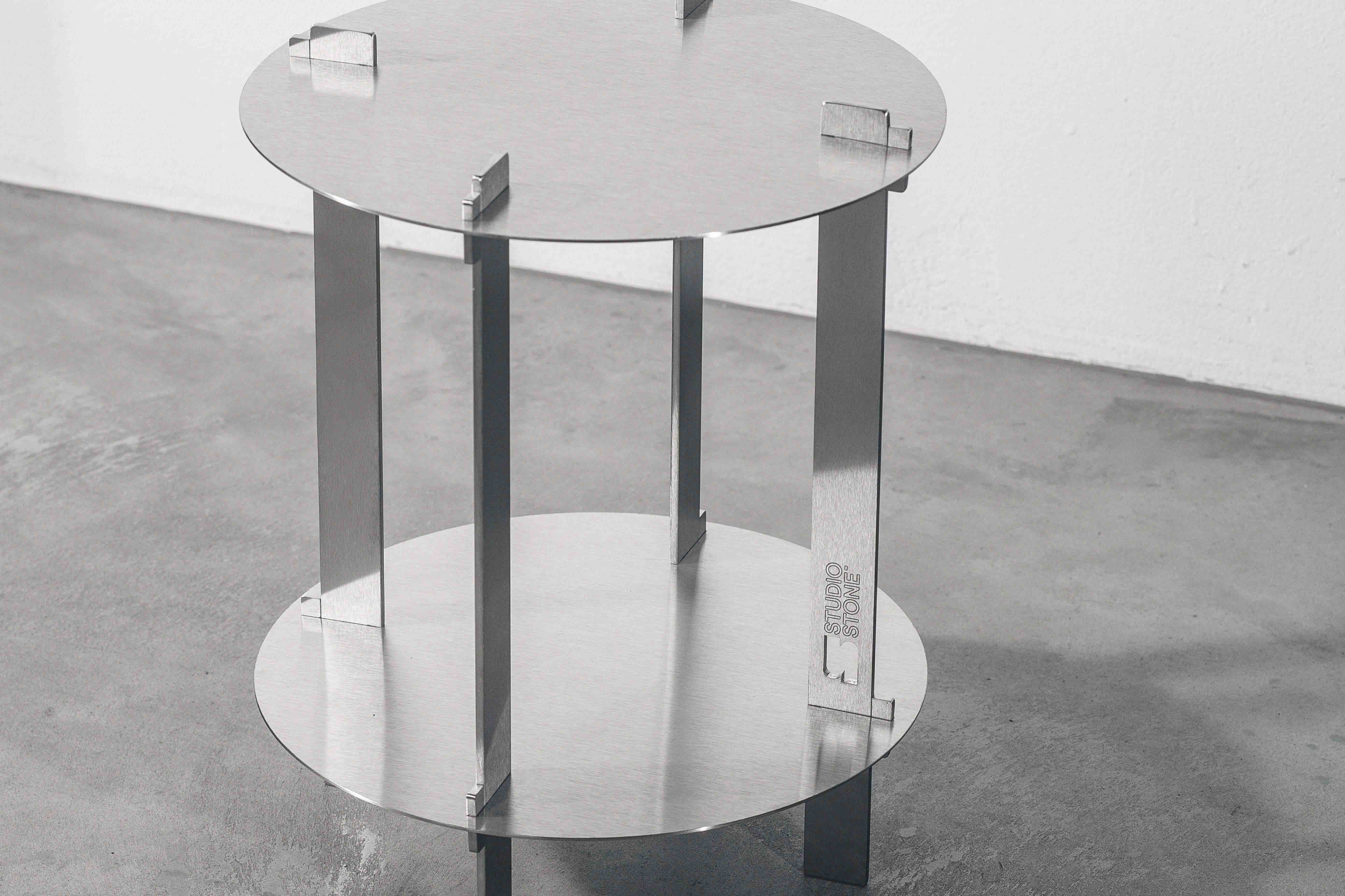detail of a metal designer table on a concrete floor