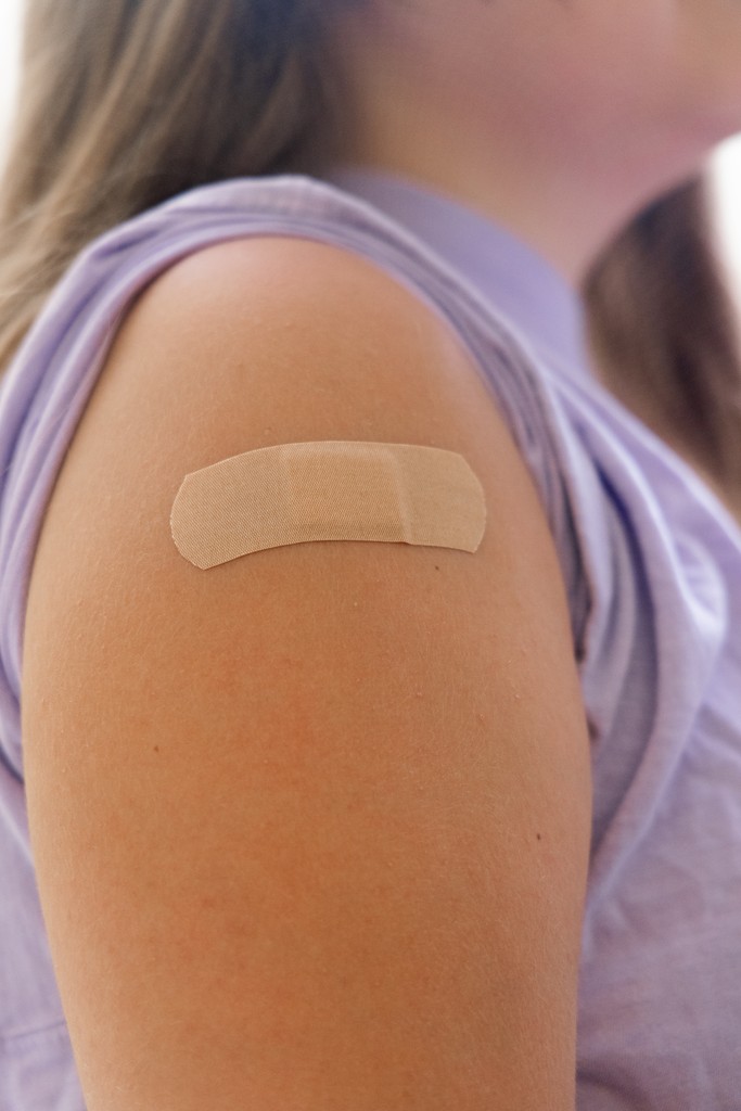 Vaccine bandage on patient's shoulder.