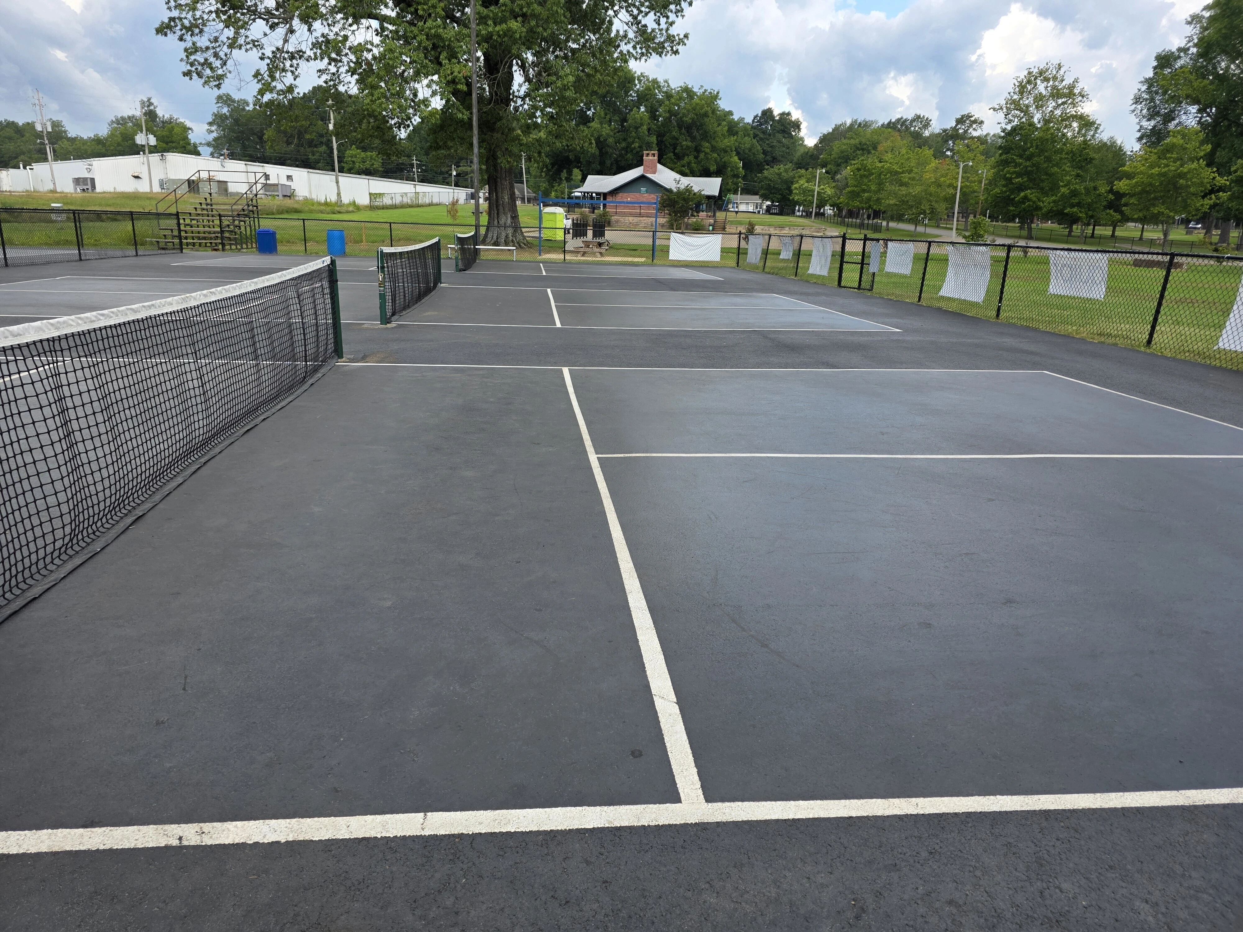 Worn tennis and pickleball courts before resurfacing at Corinth Parks & Rec in Corinth, MS