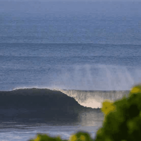 A large wave crashing on the shore - surfboard rental in el-sunzal.