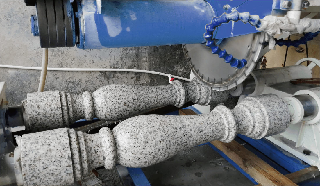 Stone balusters being cut by the Bridge-type Bidirectional Cuts Machine, showcasing its precision and efficiency in processing intricate stone designs.