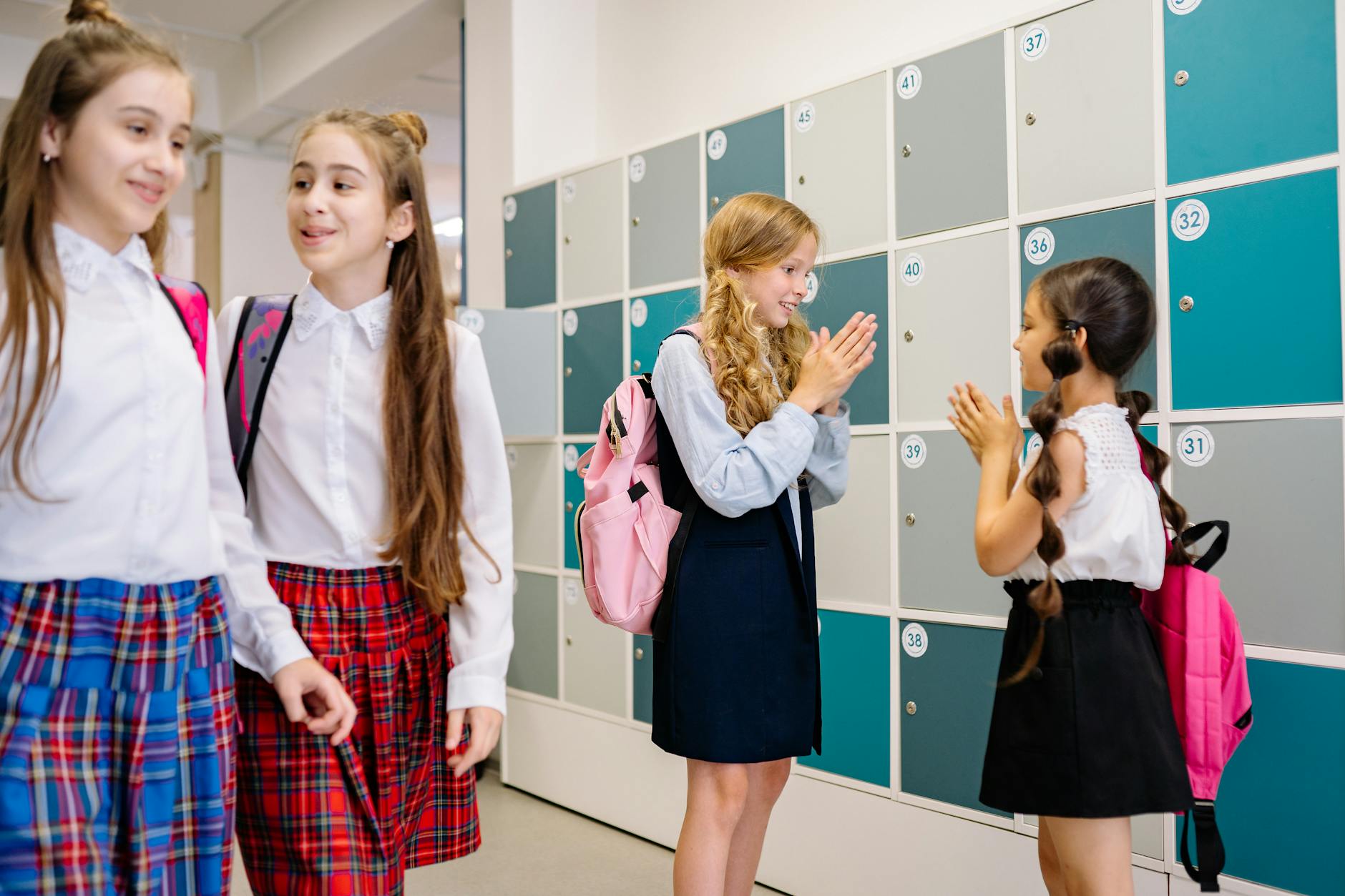 Split screen showing a teacher leading a formal department meeting and another mentoring a peer in a hallway.