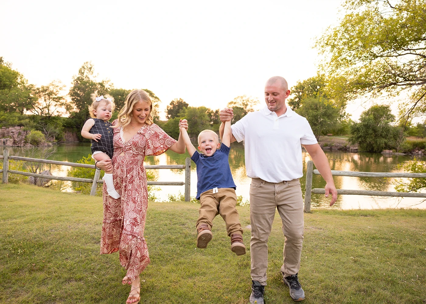Parents swinging their son between them on a walk