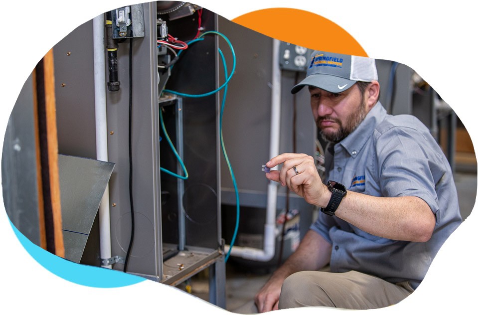 Springfield Technical Institute instructor working on HVAC equipment