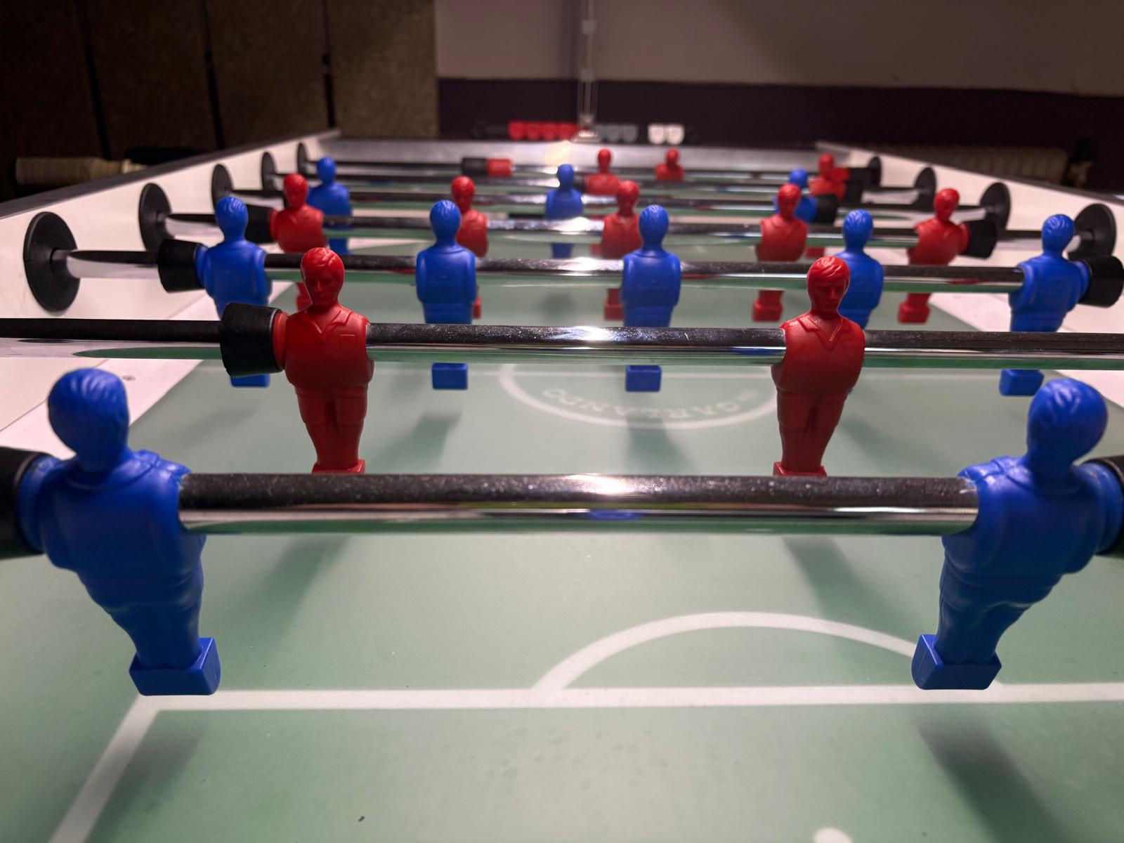 Foosball players on a green table