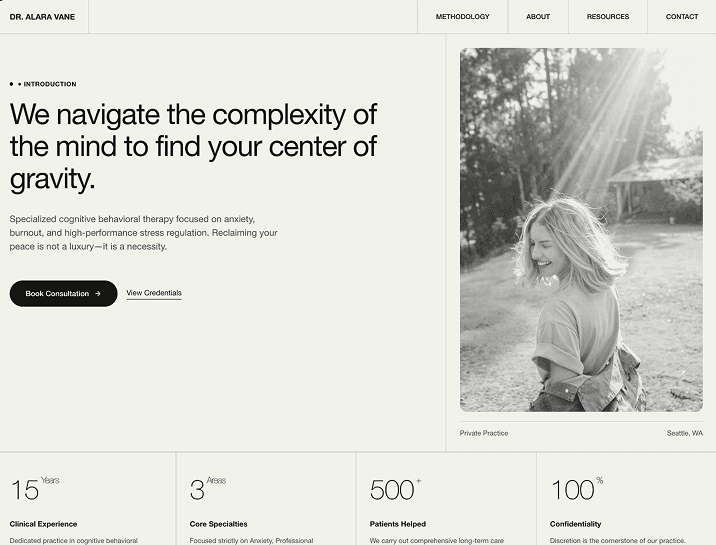 Laptop displaying code and data charts, illuminated by a desk lamp.