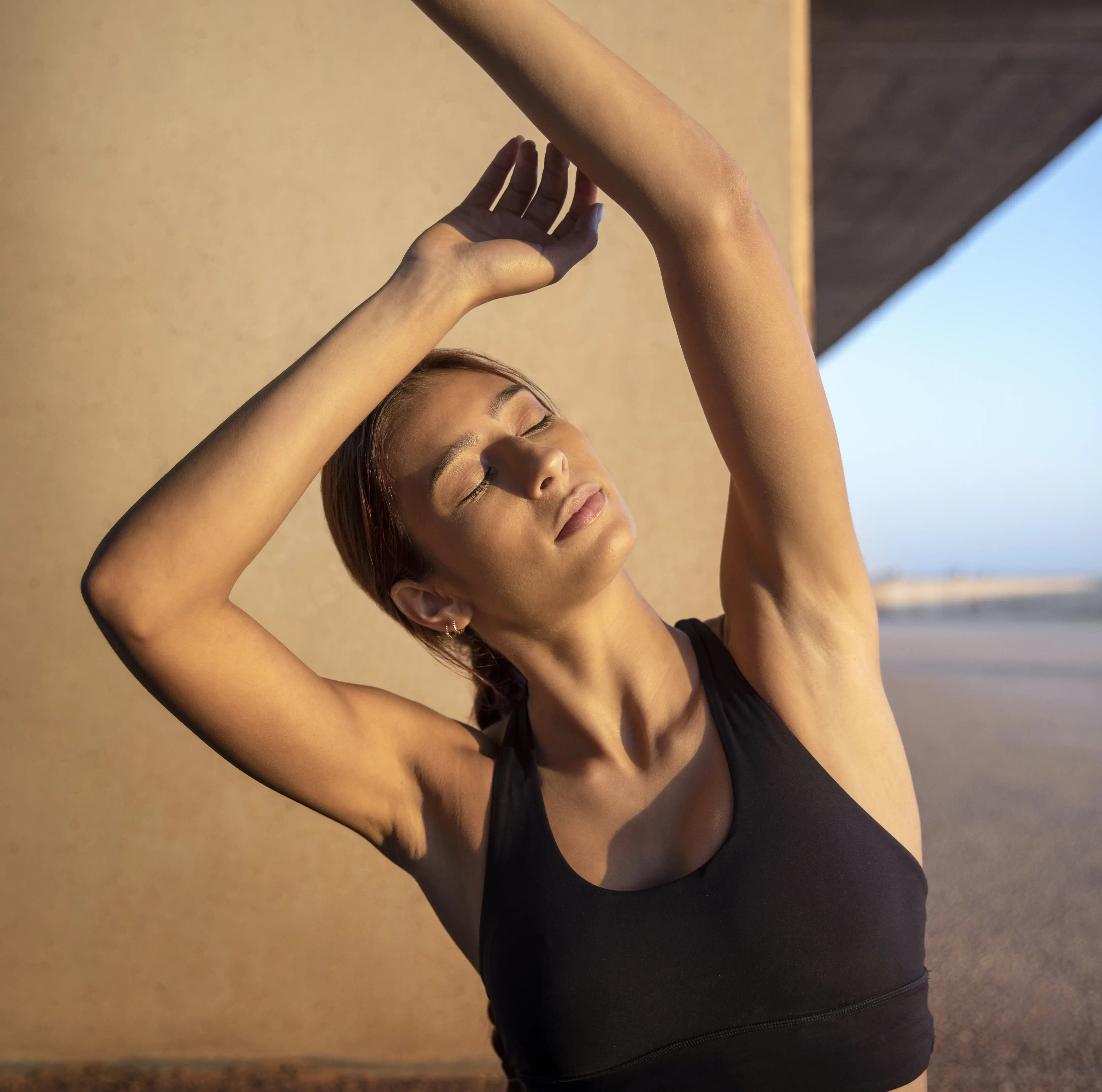 A serene spa setting with two lounge chairs beside a warm, reflective pool and soft, natural lighting.