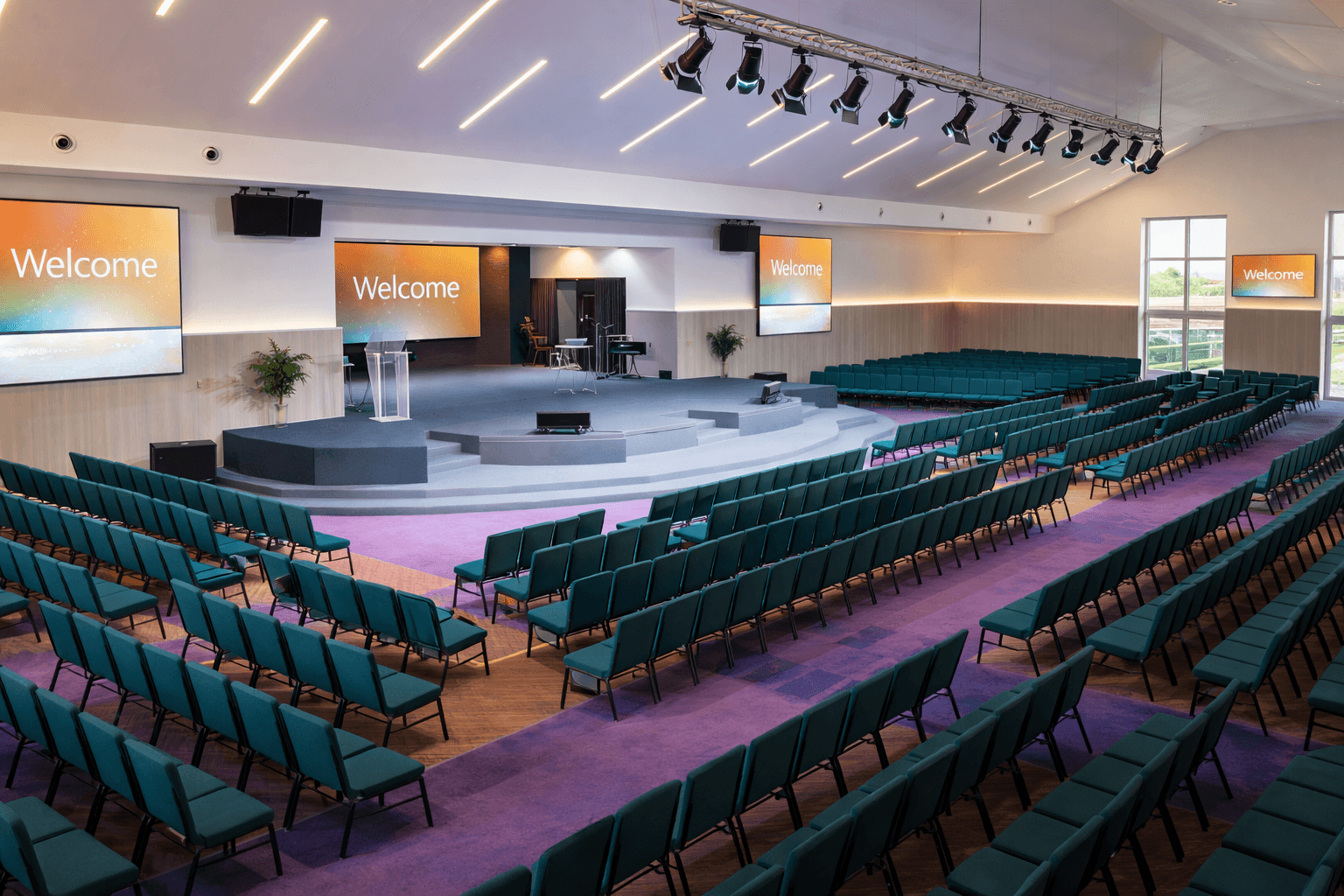 A serene pathway lined with trees leads to a distant building, bathed in warm sunlight.