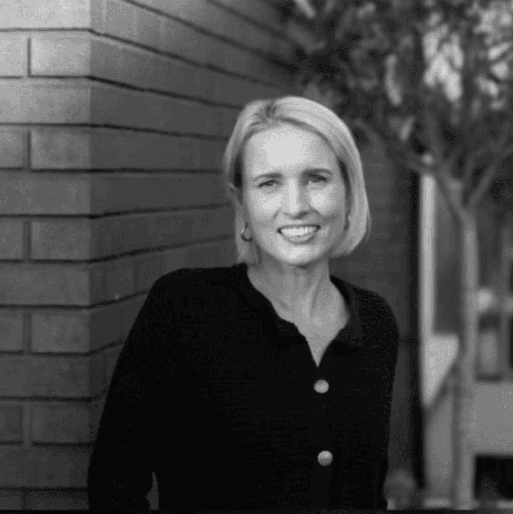 A Young woman in grey blueish background smiling