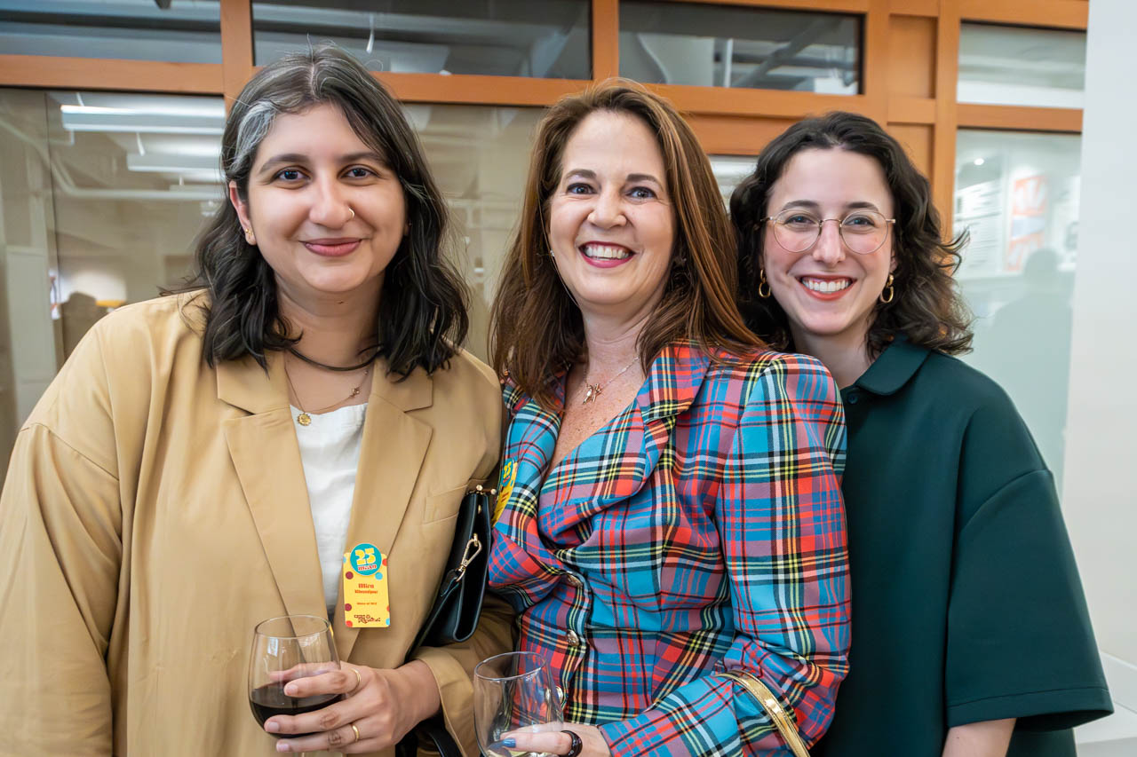 three people at cocktail party smiling for the camera