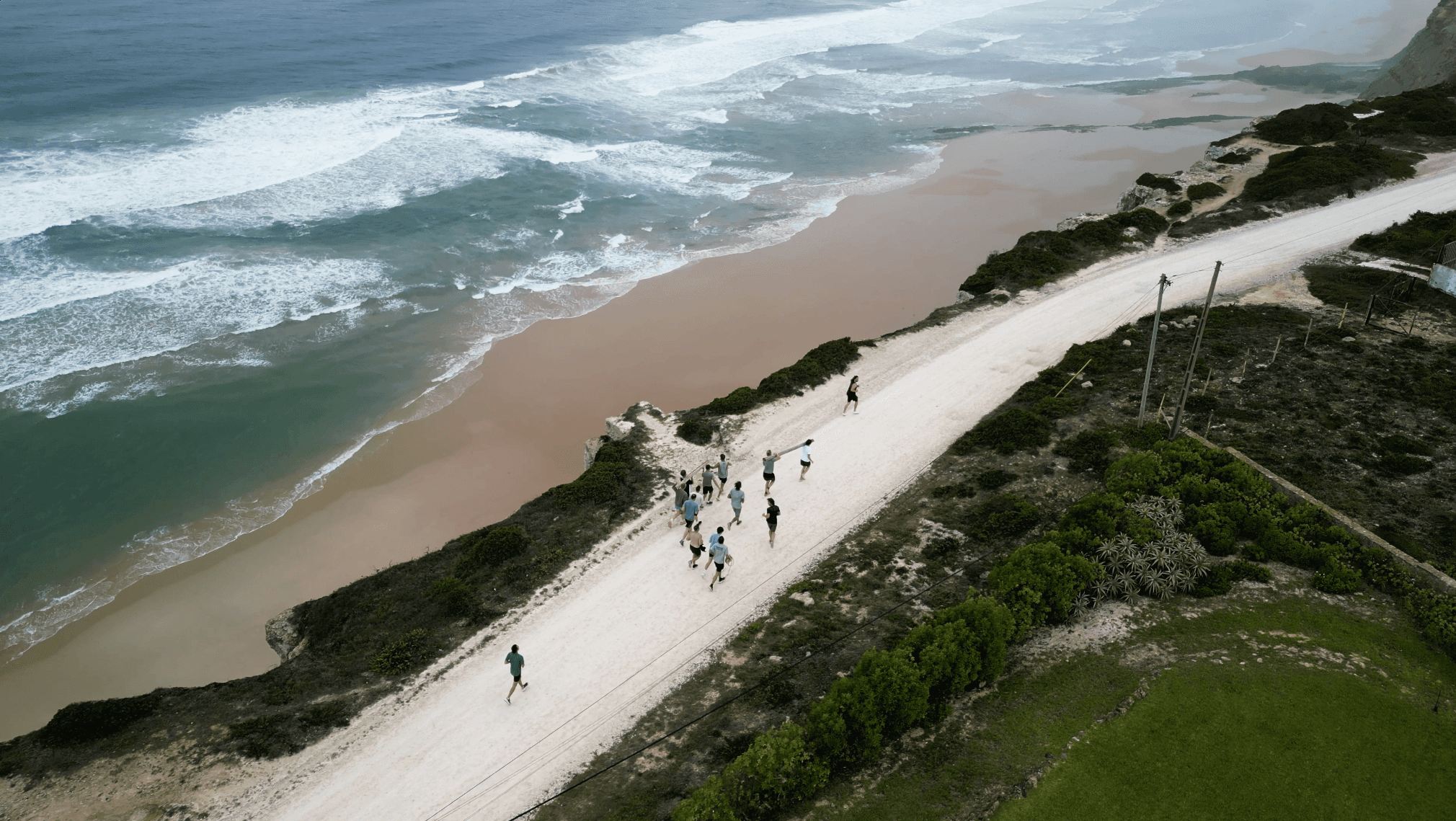 Group of men carrying a log to the beach