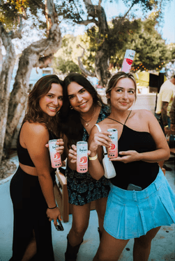 cans of hard seltzer and wine glass