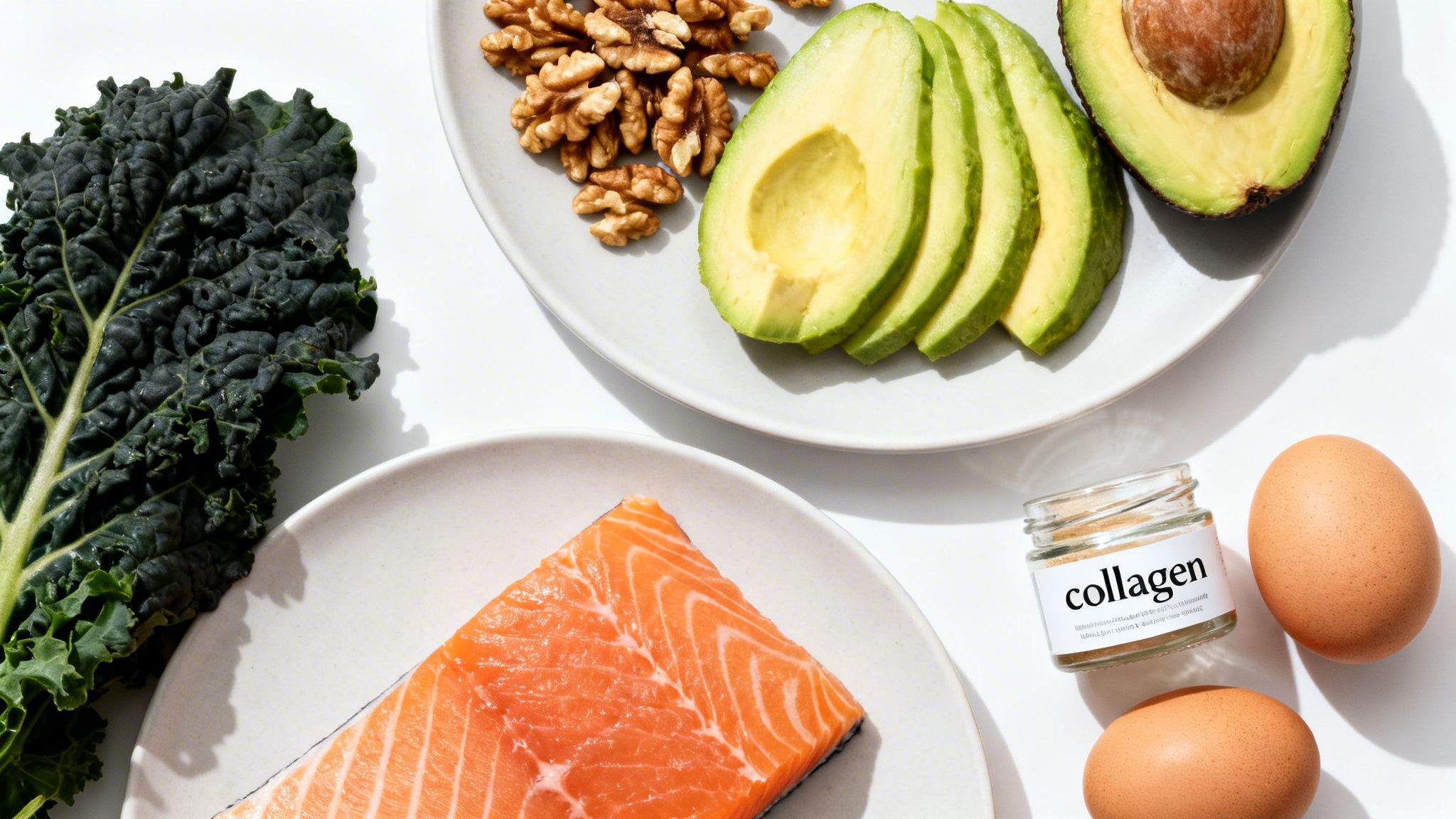 A variety of healthy foods for collagen production, including salmon, avocado, kale, walnuts, eggs, and a collagen jar.