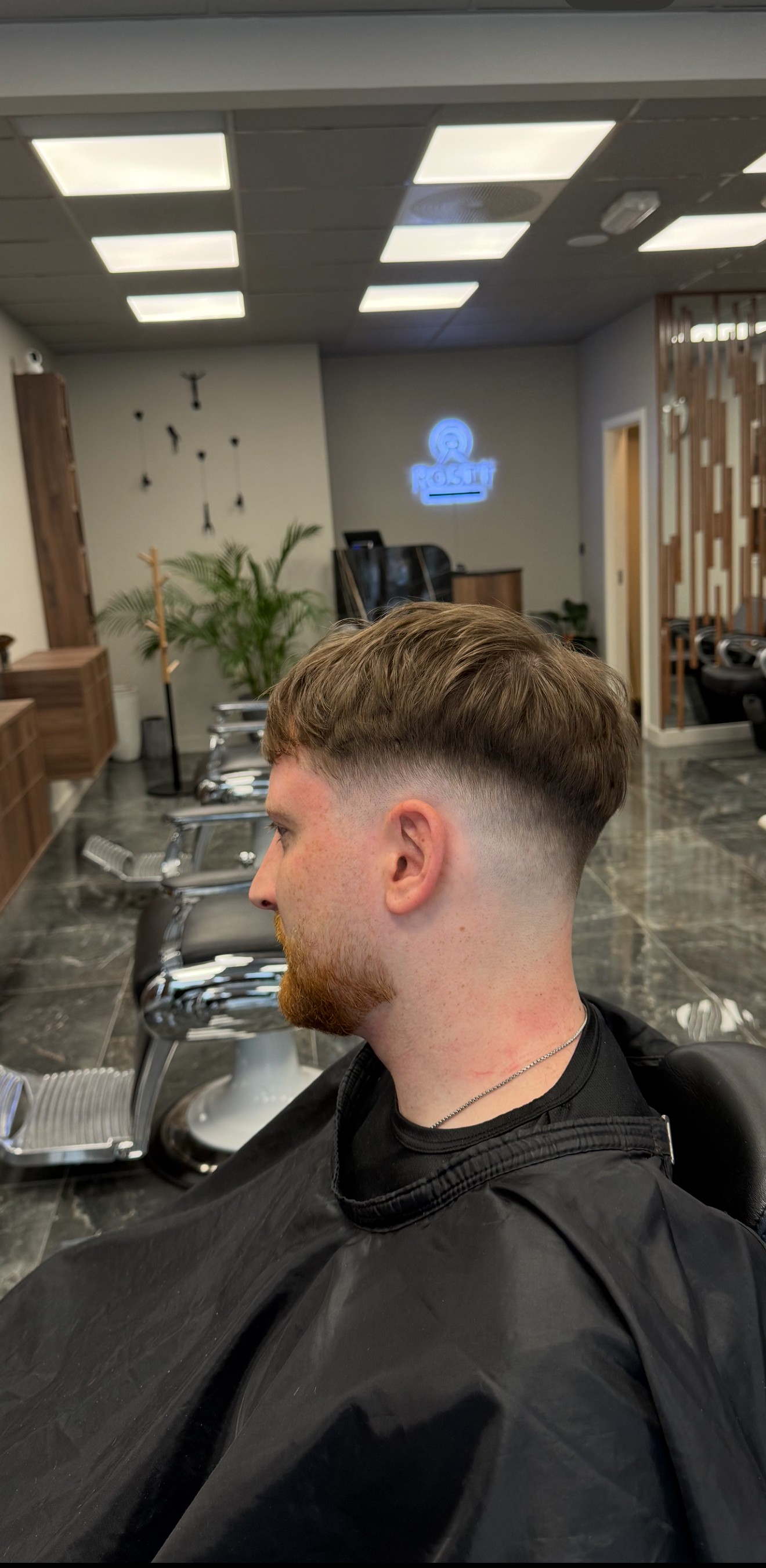 Salon styling station with gold-framed mirrors