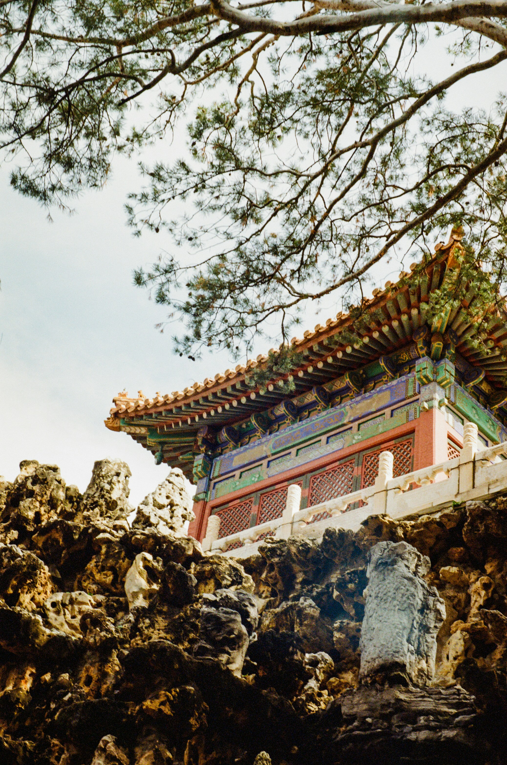 Ornate traditional chinese building behind rocky foreground