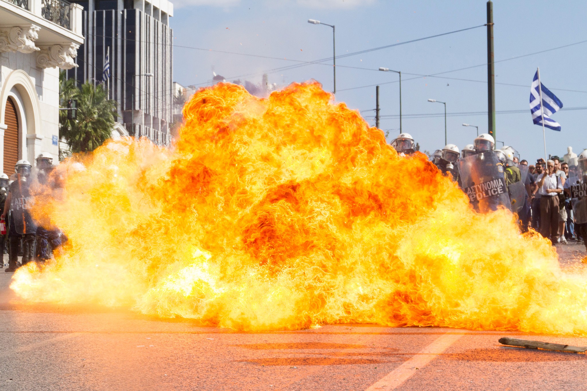 Riots in Athens, a protester is throwing a molotov cocktail. Action Photography, BBC Published