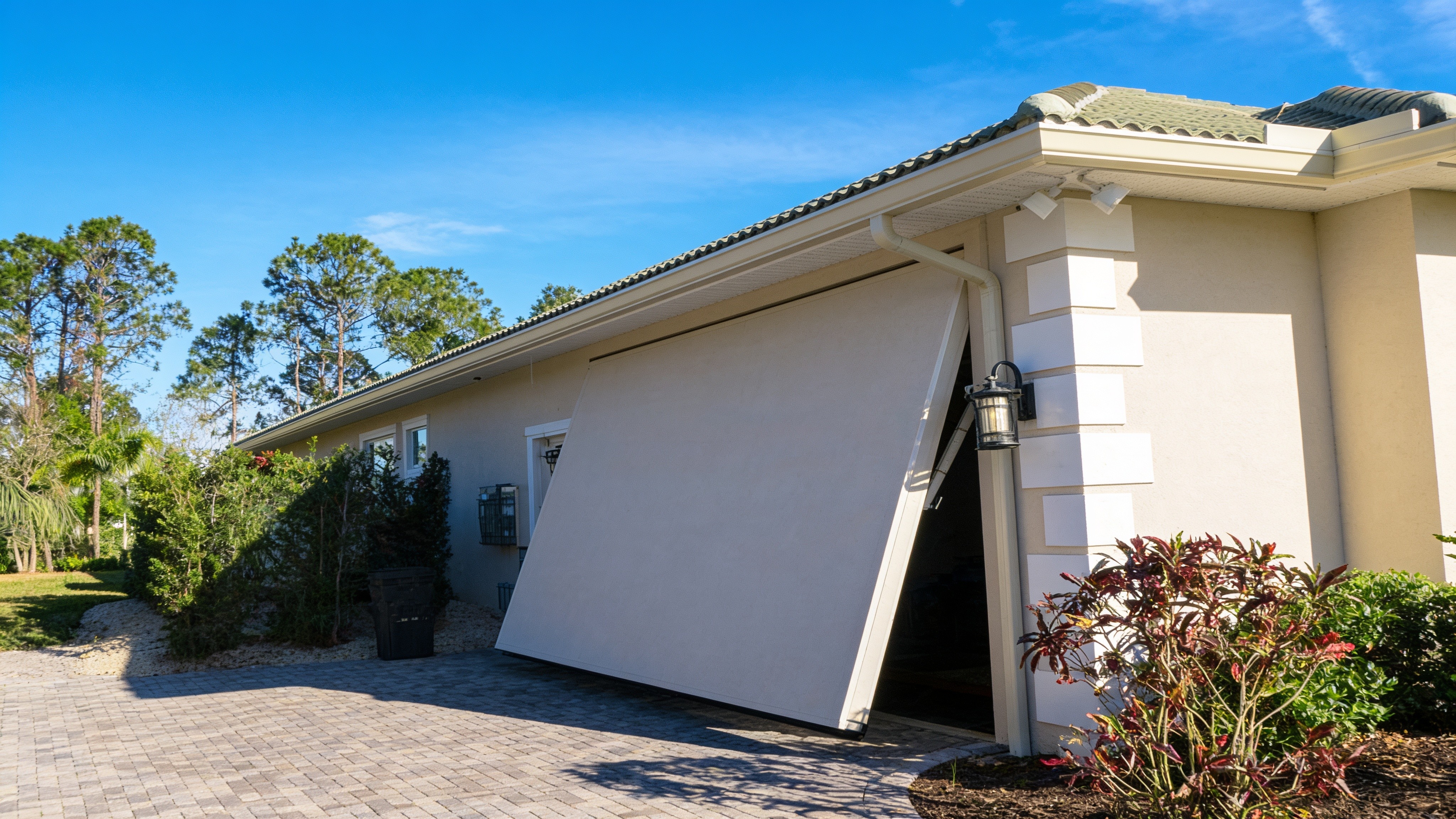 Stucco garage door closed, blending into the home exterior
