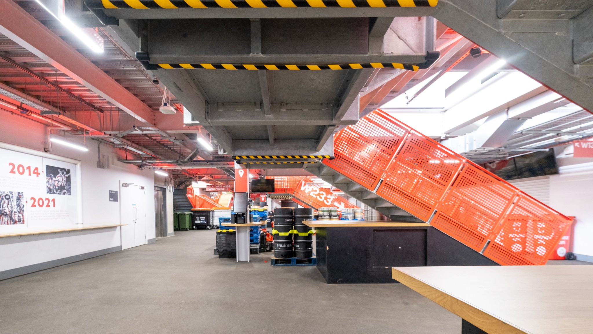 Two classic volkswagen beetles, one green, one cream.