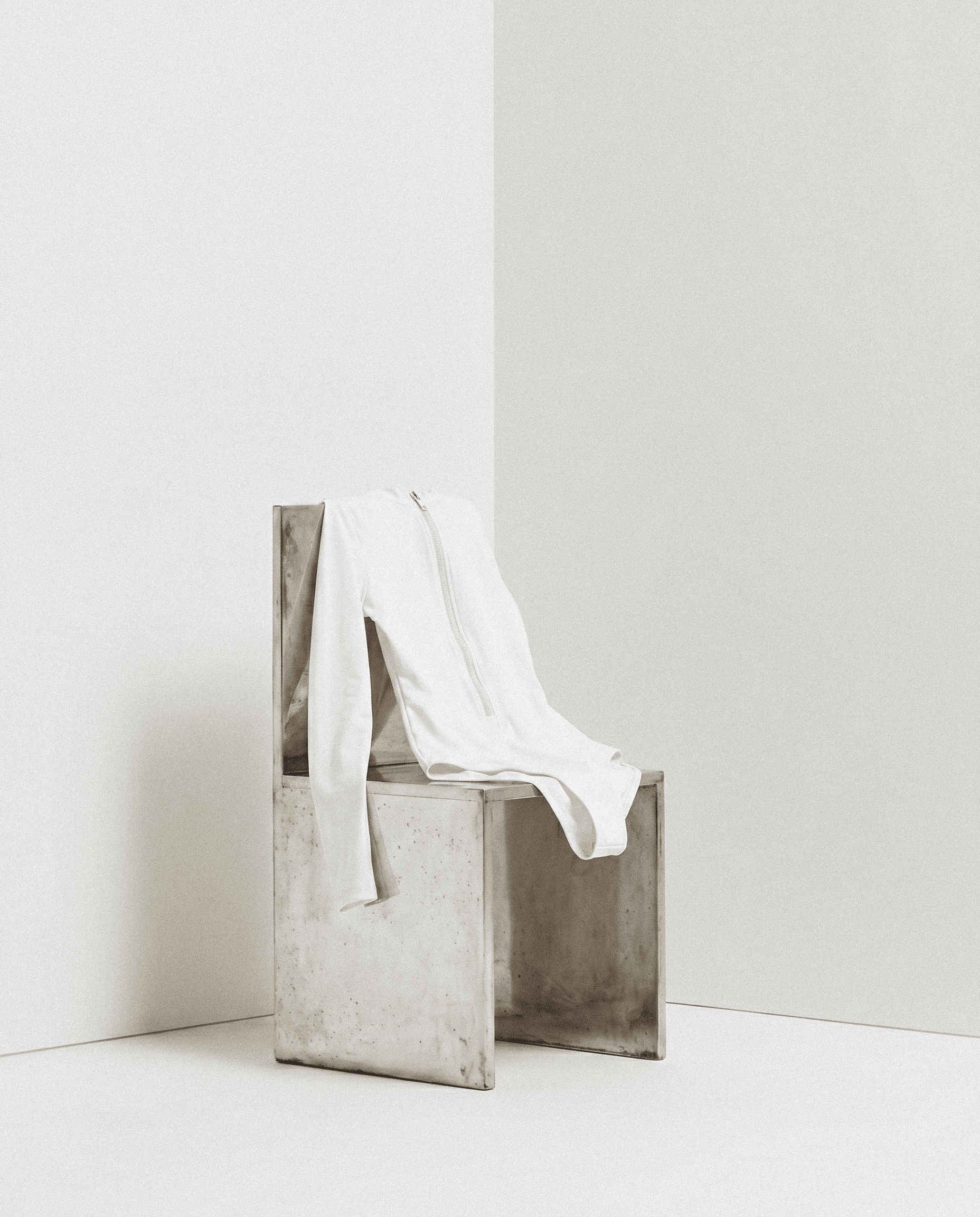 Minimalist brushed-steel chair with a withe swimsuit