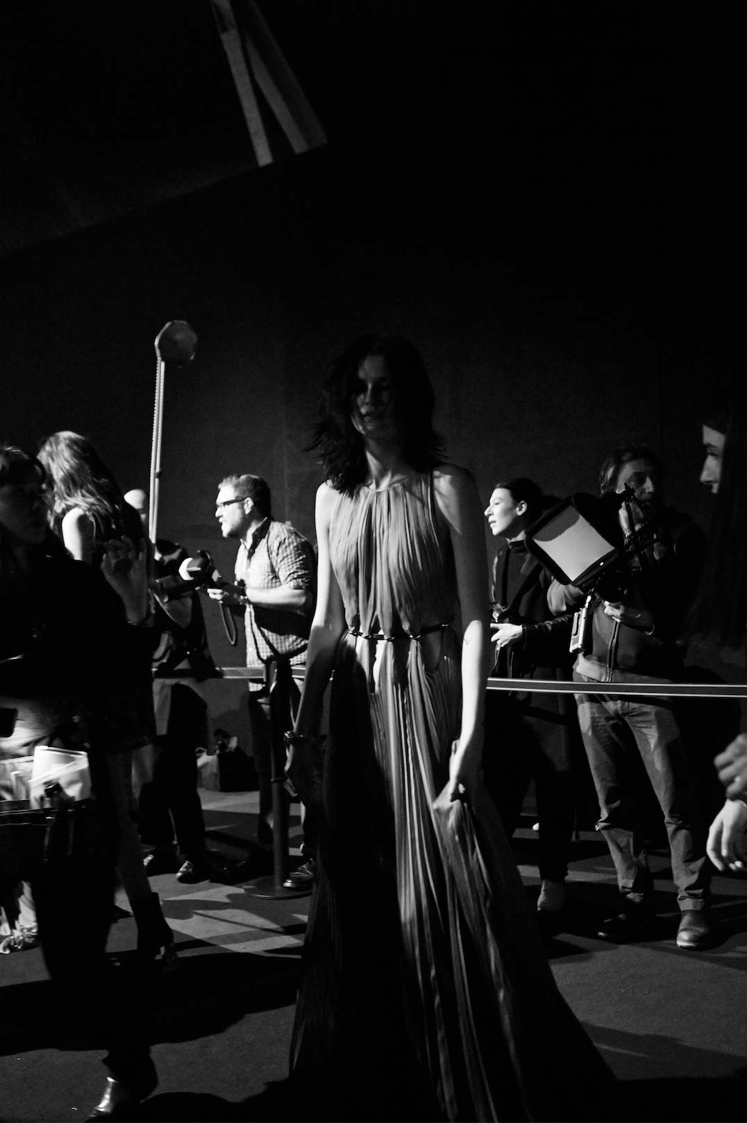 A fast black sports car races down the highway.