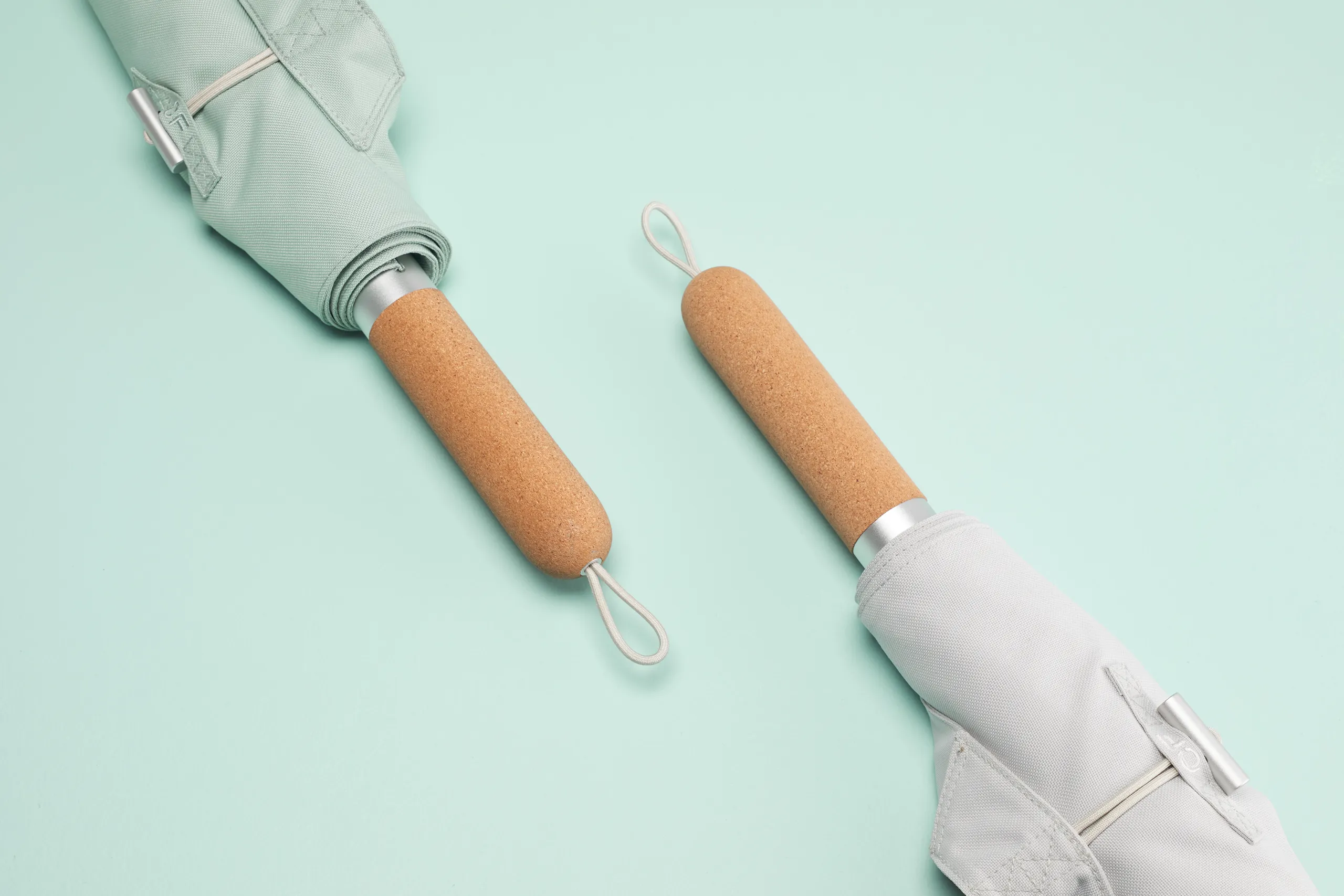 CastleFlexx cork handles and fabric strap components arranged on a light blue background